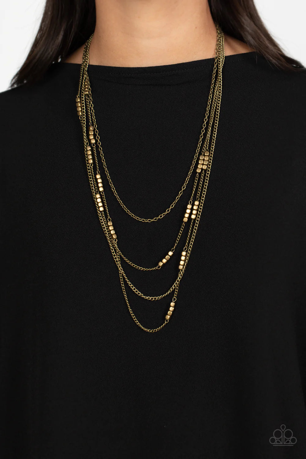 Paparazzi Accessories Metallic Monarch - Brass Glistening brass chains, sporadically infused with a quartet of brass beads link into fashionable layers below the neckline for a monochromatic medley. Features an adjustable clasp closure. Sold as one indivi