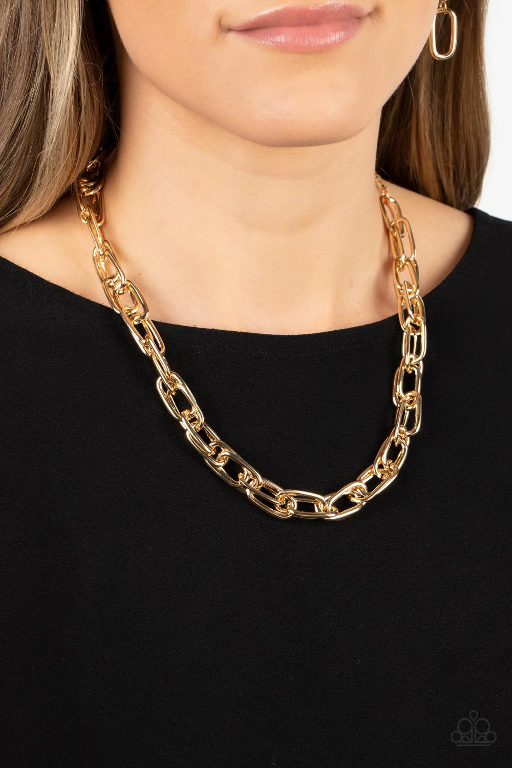 Paparazzi Accessories Tough Call - Gold A gritty collection of oversized oval gold links boldly interlocks below the collar, resulting in an intense industrial look. Features an adjustable clasp closure. Sold as one individual necklace. Includes one pair