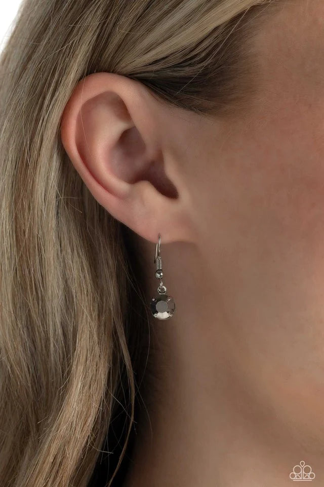 Paparazzi Accessories Edgy Exaggeration - Green Featuring an elegant lariat closure, an oversized, faceted, stellar green UV shimmery teardrop gem, encased in an elevated pronged silver frame cascades from the bottom of a silver curb chain in a whimsical