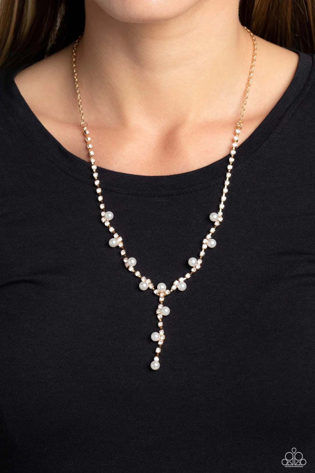 Paparazzi Accessories Upper Class - Gold Attached to a section of dainty gold links, white rhinestones, pressed into shiny gold box chain fittings swing down the neckline in a lariat-like manner for an effulgent glow. Sporadically infused along the box ch