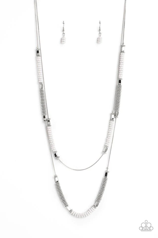Paparazzi Accessories Caviar Chic - White Featuring a layered display, two elongated silver snake chains dance down the neckline. Sections of shiny silver flower beads, capped by high sheen silver accents, are interspersed with stacks of white and silver
