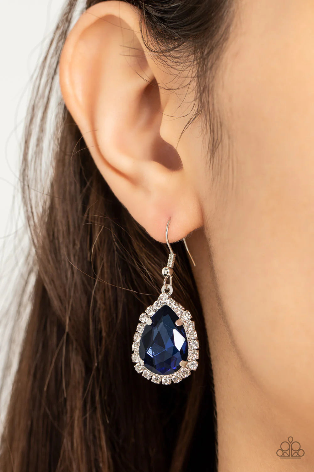 Paparazzi Accessories Bippity Boppity Boom! - Blue A border of glassy white rhinestones creates a glittery trim around an oversized blue teardrop gem, resulting in a stunning centerpiece. Earring attaches to a standard fishhook fitting. Sold as one pair o