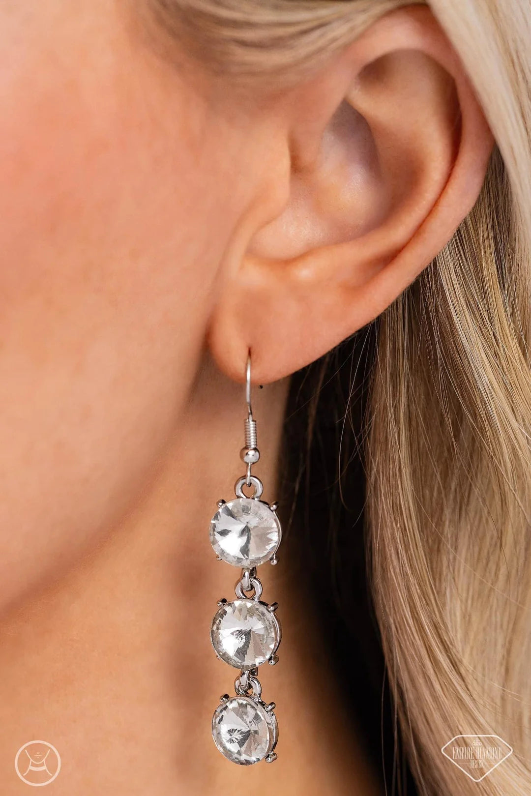 Paparazzi Accessories Gods Girl - White ! A flashy collection of oversized white gems wraps along the neckline, leading to a polished silver plate in the center. The phrase “God’s Girl” is inscribed on the metallic centerpiece in a decorative font, as a d