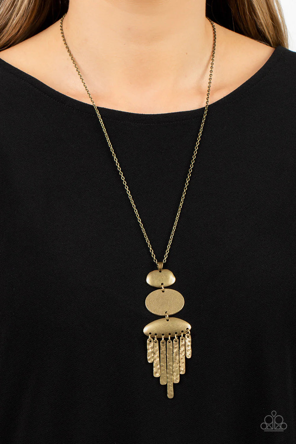 Paparazzi Accessories After the ARTIFACT - Brass A hammered brass oval frame is flanked between two asymmetrical brass frames at the bottom of a lengthened brass chain. Hammered brass pendulums swing from the bottom of the stacked pendant, adding playful