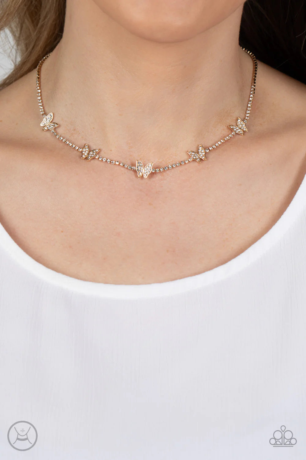 Paparazzi Accessories Fluttering Fanatic - Gold Infused along a row of dainty white rhinestones pressed into gold box-chain settings, a collection of gold butterflies coalesces around the neckline for a whimsical finish. Each butterfly features a dainty s
