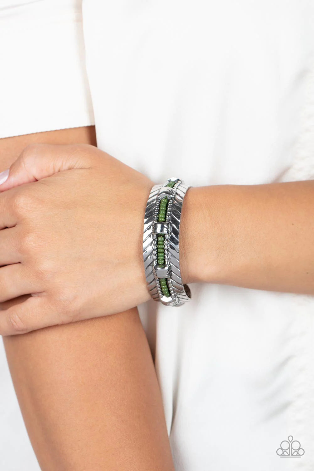 Paparazzi Accessories Sonoran Scene - Green A row of Olive Branch seed beads is threaded along a wire inside a studded silver frame as it flows around a silver cuff. Flared antiqued silver accents embellish the edges of the cuff for a rustic finish. Sold