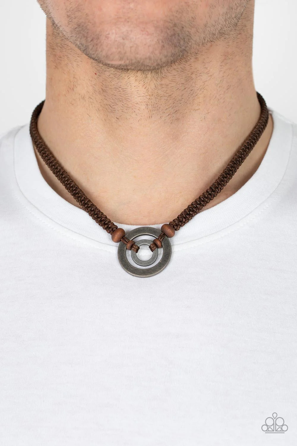 Paparazzi Accessories Rural Reed - Brown Infused with dainty wooden beads, two tin-finished silver rings are knotted in place along a braided strand of brown cording below the collar for an earthy flair. Features a button loop closure. Sold as one individ