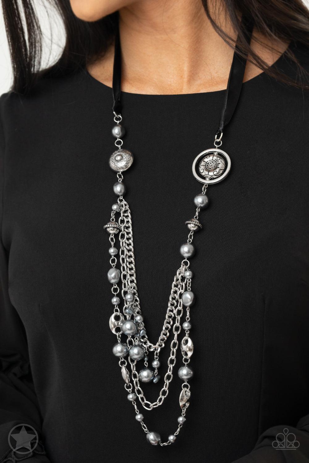 Paparazzi Accessories All The Trimmings - Black A silky black ribbon replaces a traditional chain to create a timeless look. Pearly dark gray beads and funky silver pieces intermix with varying lengths of silver chains to give a fresh take on a Victorian-