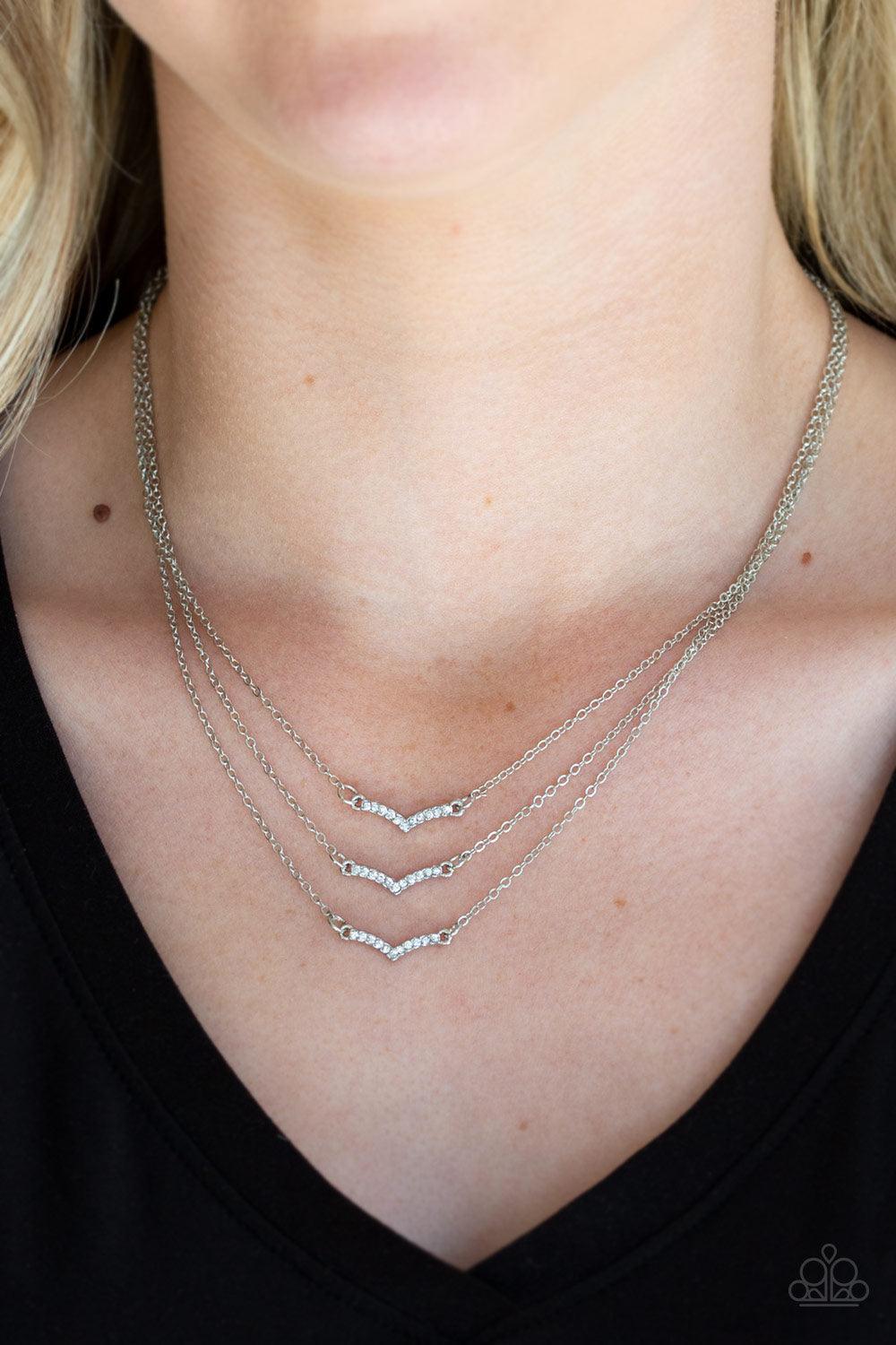 Paparazzi Accessories Pretty Petite - White Encrusted in glassy white rhinestones, three dainty silver frames layer below the collar for a classic look. Features an adjustable clasp closure. Sold as one individual necklace. Includes one pair of matching e