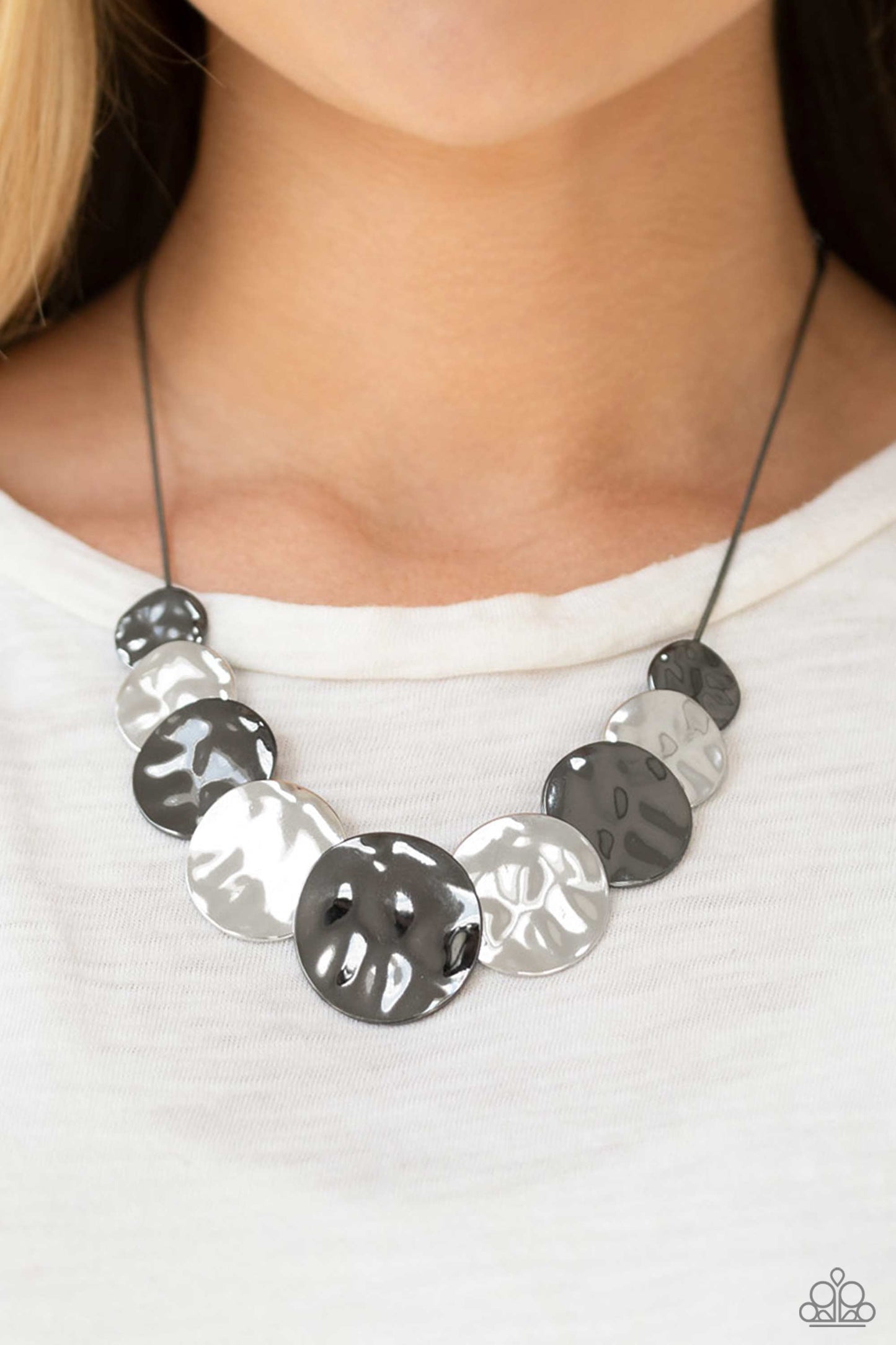 Paparazzi Accessories A Daring DISCovery - Black Gradually increasing in size near the center, hammered gunmetal and silver discs slide along a gunmetal wire chain below the collar for an edgy look. Features an adjustable clasp closure. Sold as one indivi