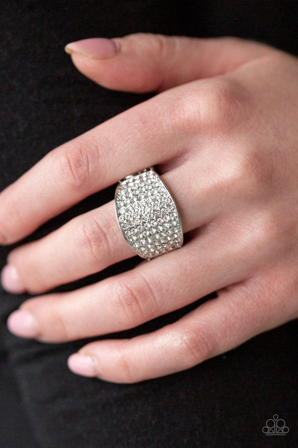 Paparazzi Accessories Kaboom! - White Countless white rhinestones are encrusted along a thick silver band for a spellbinding look. Features a stretchy band for a flexible fit. Sold as one individual ring. Jewelry