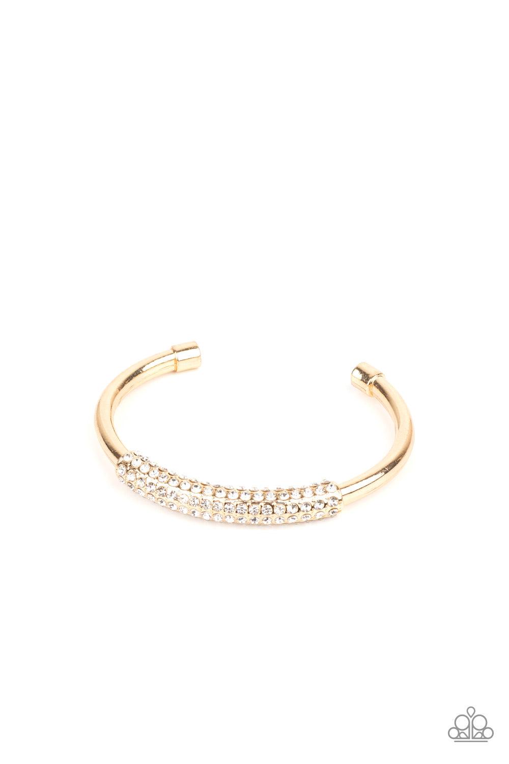 Paparazzi Accessories Day to Day Dazzle - Gold The center of a thick bangle-like cuff is decorated in a sleek gold frame encrusted in row after row of glassy white rhinestones for a refined flair. Sold as one individual bracelet. Jewelry
