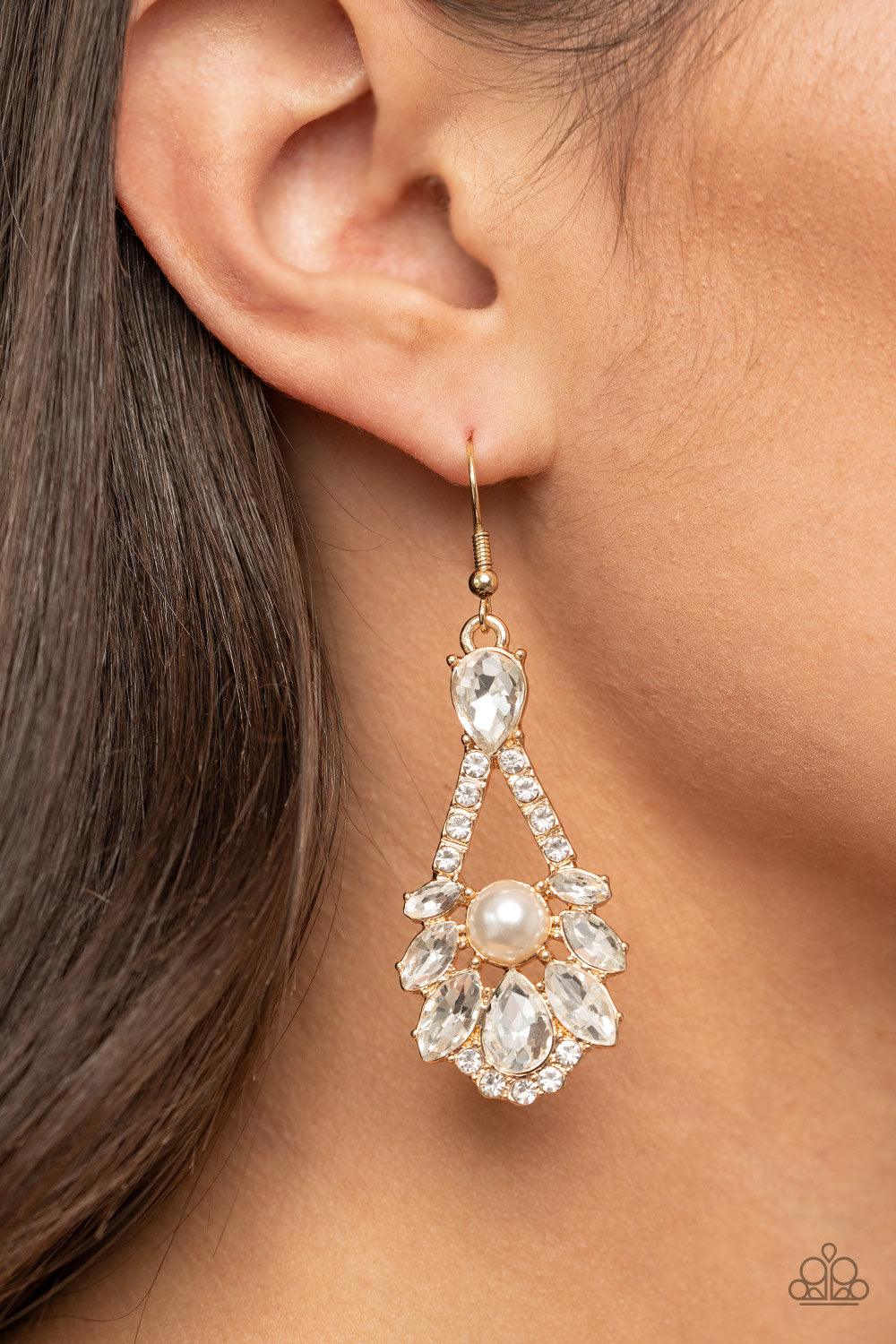Paparazzi Accessories Prismatic Presence - Gold A sparkly series of marquise and teardrop white rhinestones embellish the front of a white rhinestone encrusted gold frame. A dainty white pearl adorns the center, adding a splash of vintage refinement. Earr
