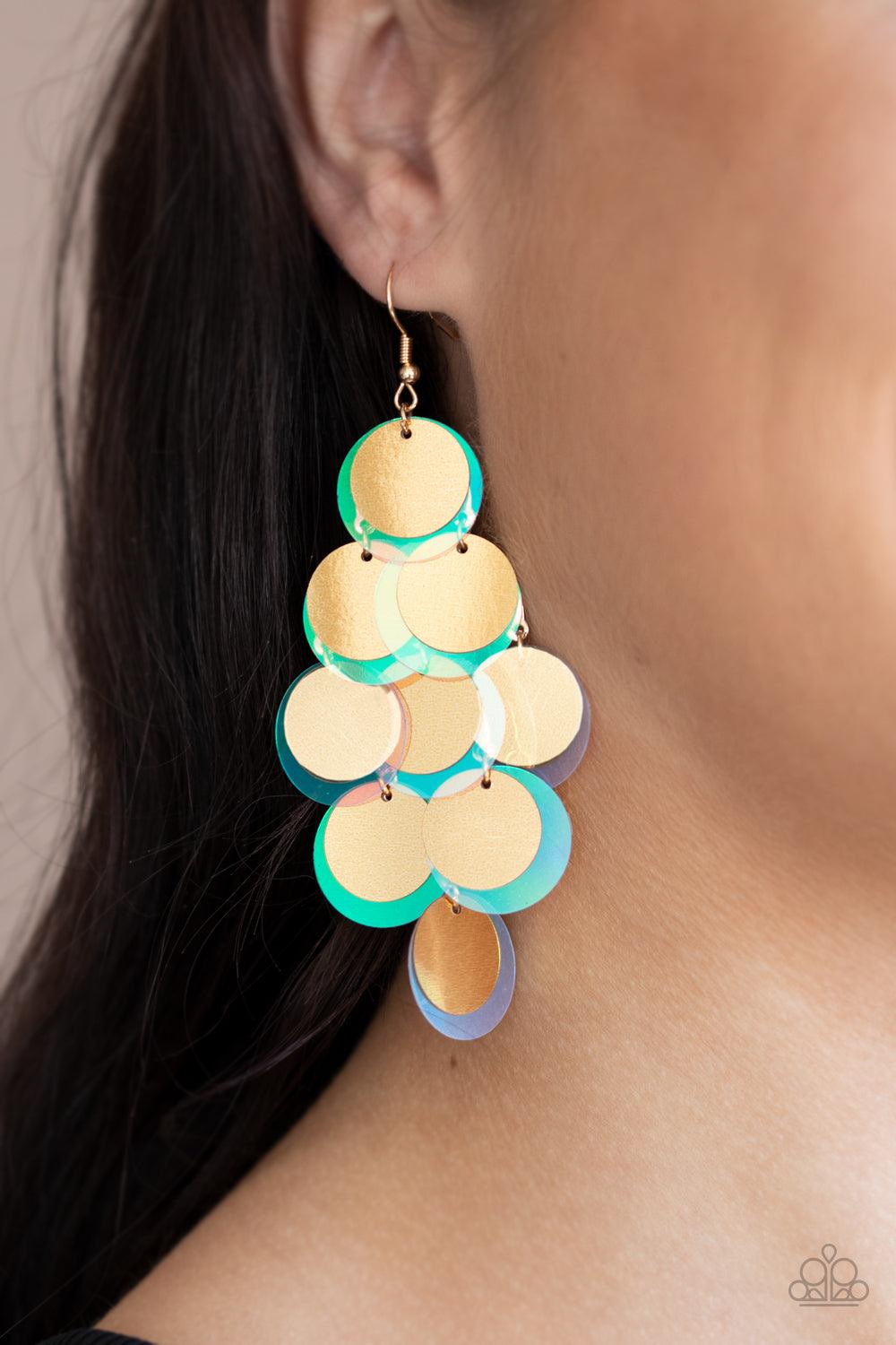 Paparazzi Accessories Sequin Seeker - Gold A bubbly collection of oversized gold and iridescent sequins cascade from the ear, creating a flirty holographic fringe. Earring attaches to a standard fishhook fitting. Sold as one pair of earrings. Jewelry