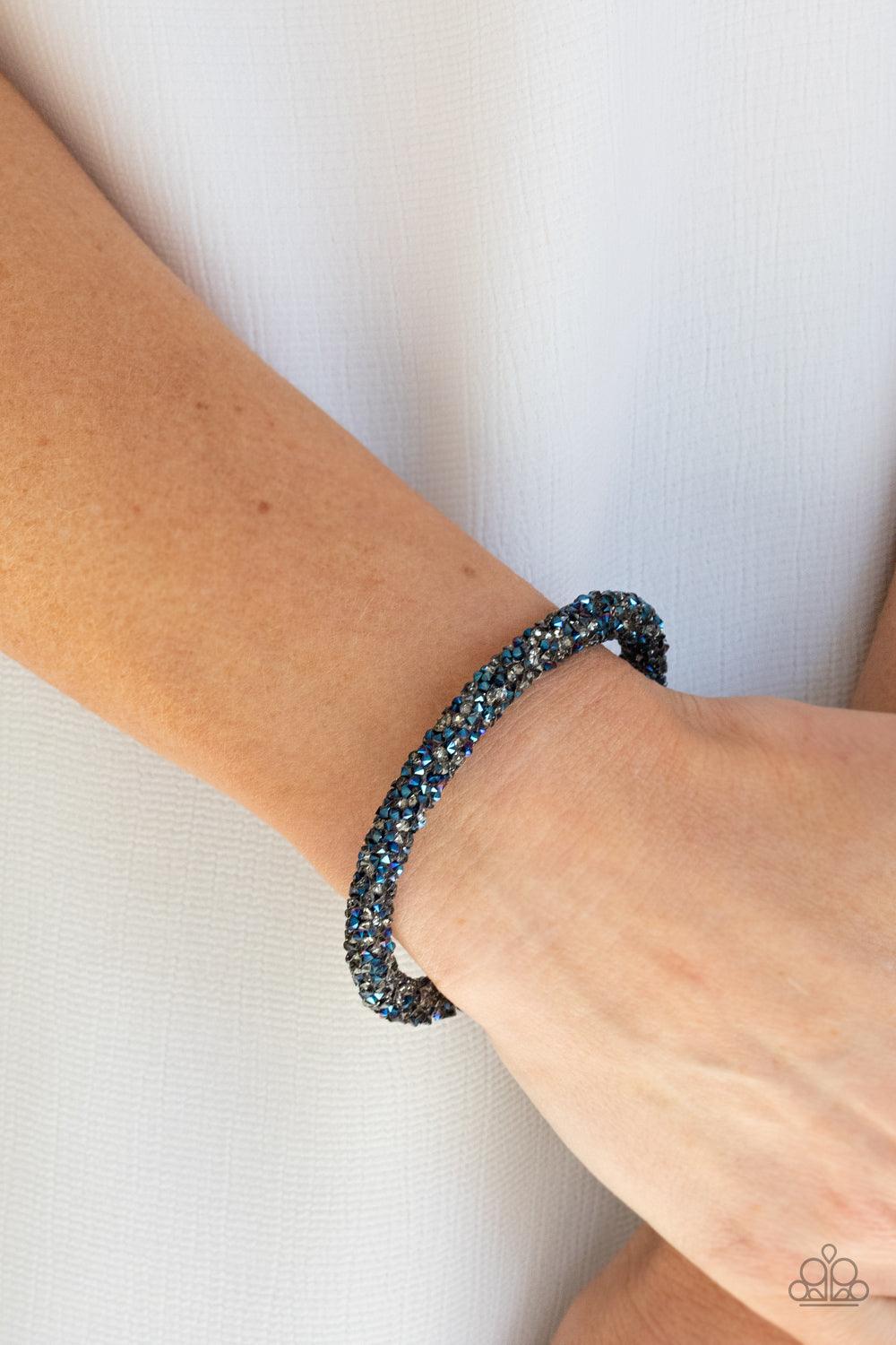 Paparazzi Accessories Roll Out The Glitz - Multi As if rolled in glitter, a seemingly infinite collection of metallic blue and smoky rhinestones adorns a flexible band that delicately coils around the wrist for a sparkly versatile fit. Sold as one individ