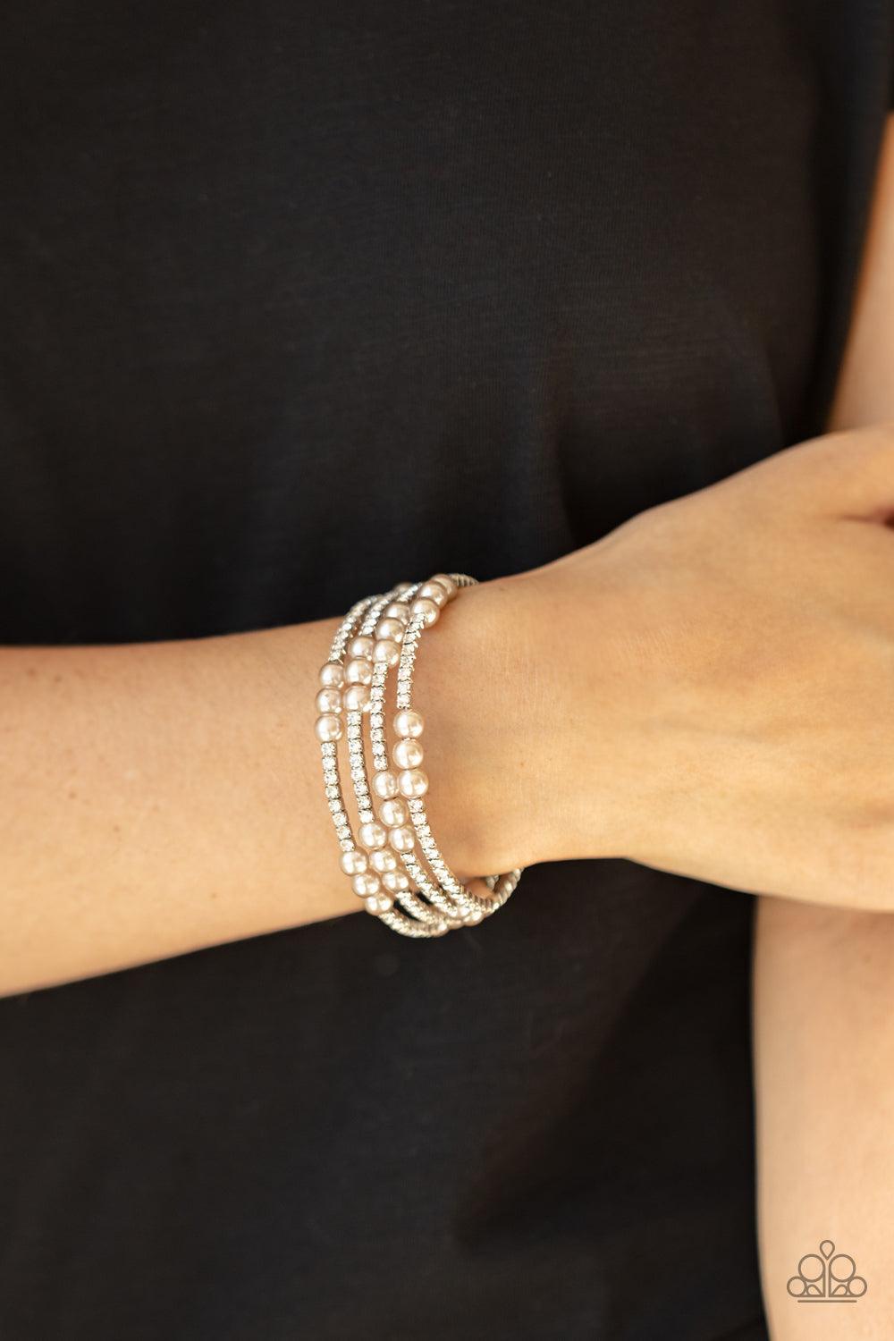 Paparazzi Accessories Hollywood Hospitality - Brown Sparkly sections of glassy white rhinestones and classic brown pearls are delicately threaded along a coiled wire, creating a glamorous infinity wrap style around the wrist. Sold as one individual bracel