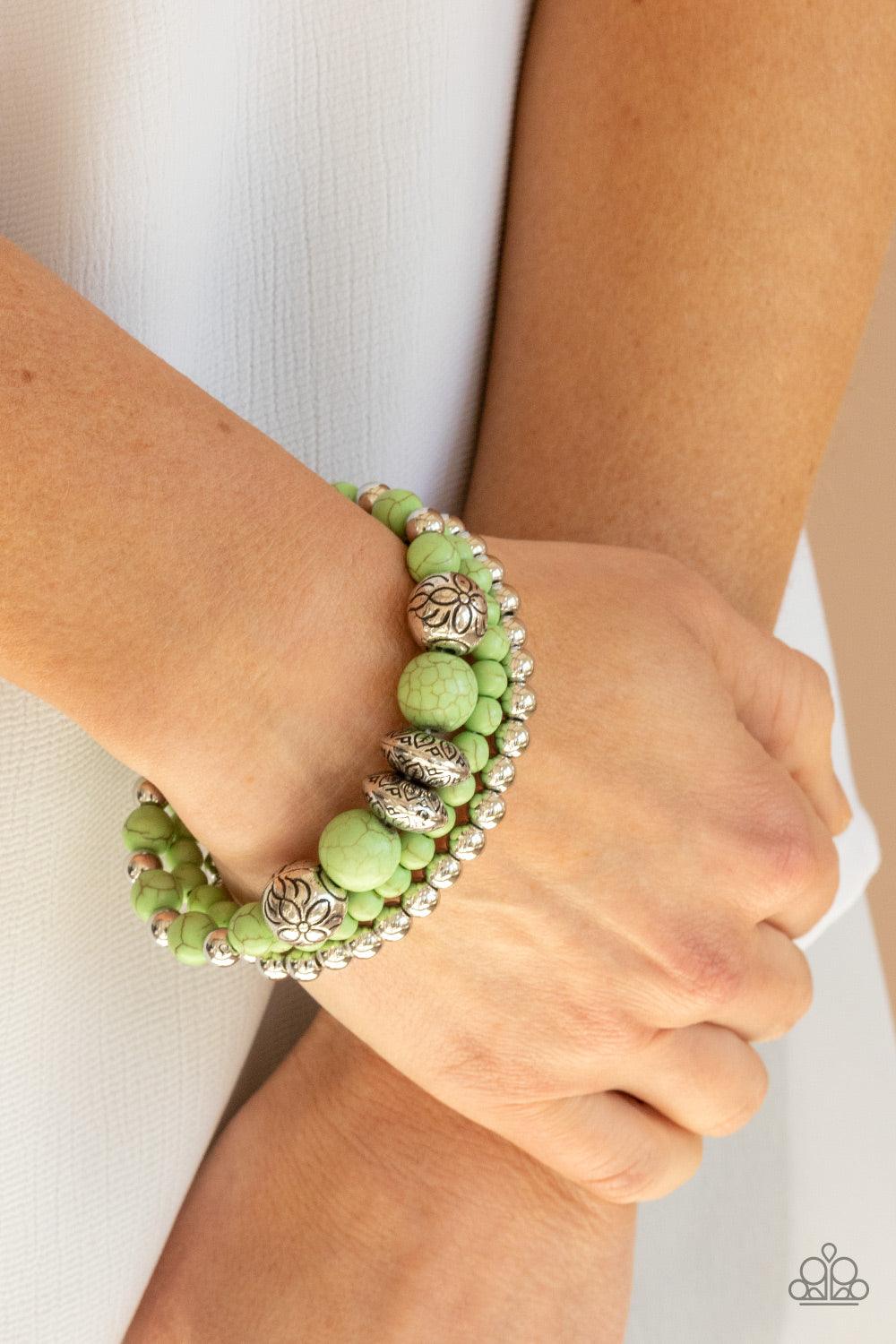 Paparazzi Accessories Desert Blossom - Green A whimsically mismatched collection of green stone beads, plain silver beads, and antiqued floral accents are threaded along stretchy bands around the wrist, creating colorful layers. Sold as one set of three b