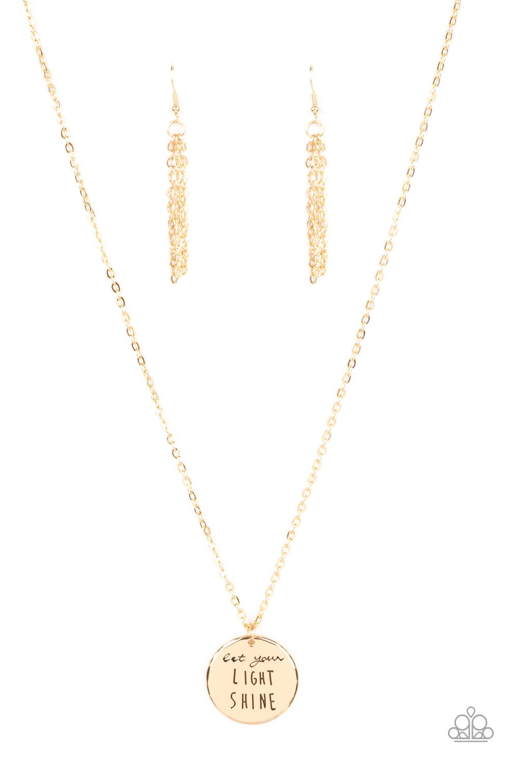Paparazzi Accessories Light It Up - Gold A glistening gold disc is stamped in the inspiring phrase, "Let your light shine," at the bottom of a shiny gold chain. Features an adjustable clasp closure. Sold as one individual necklace. Includes one pair of ma