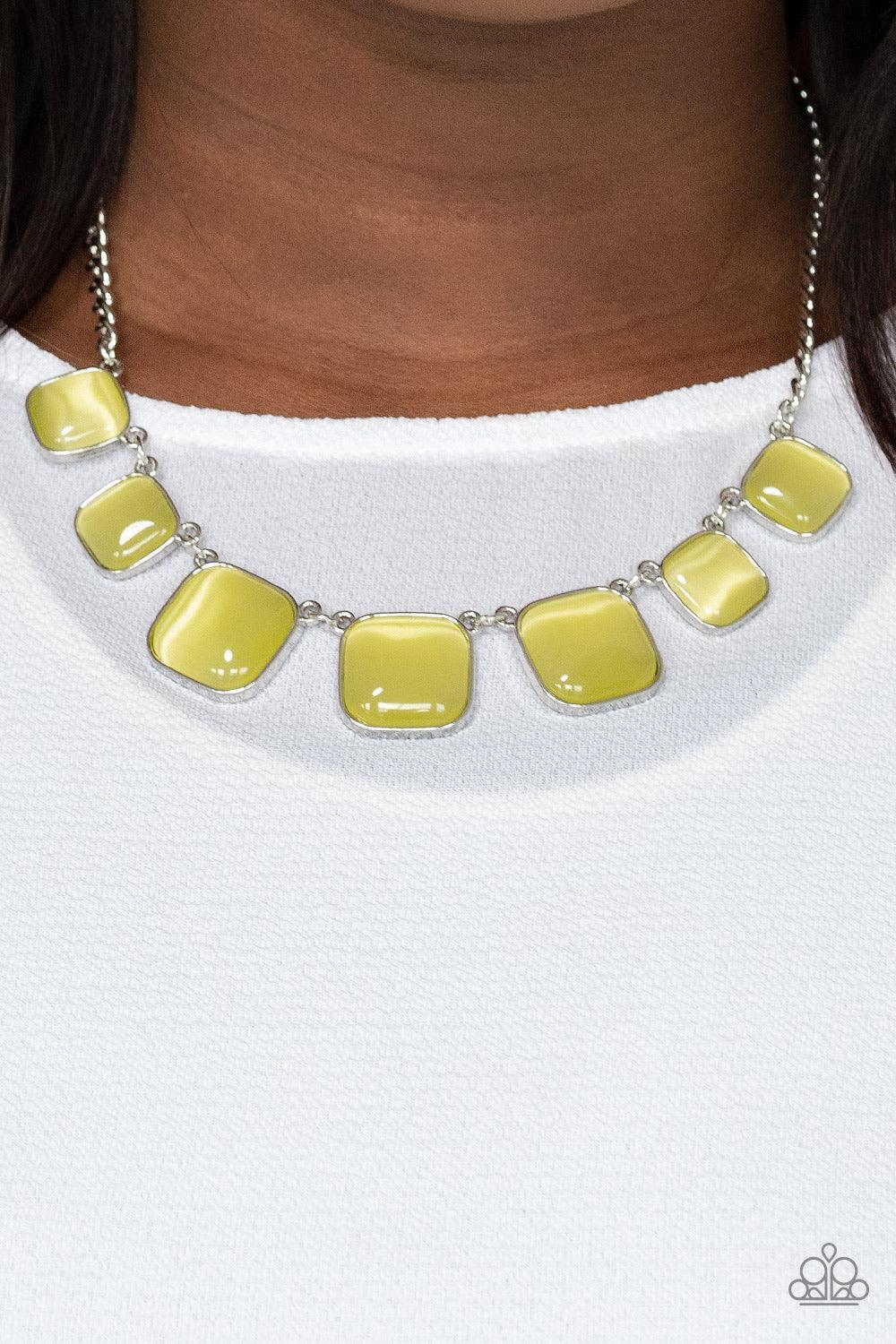 Paparazzi Accessories Aura Allure - Yellow Encased in square silver fittings, a dewy collection of Illuminating cat's eye stones gradually increase in size as they link below the collar for a whimsical pop of color. Features an adjustable clasp closure. S