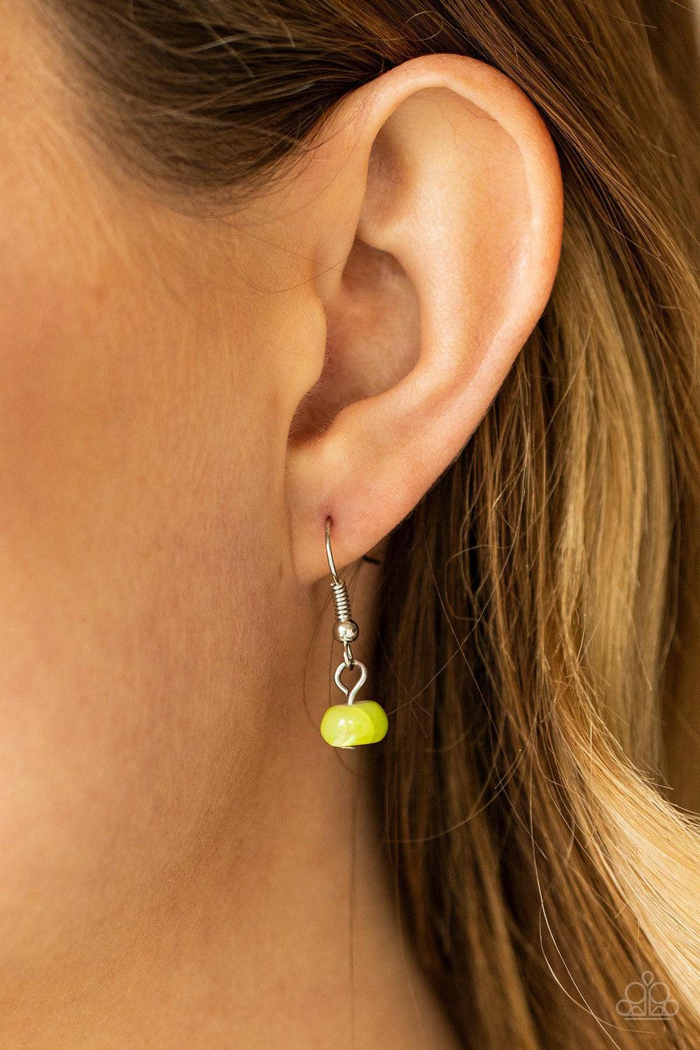 Paparazzi Accessories Staycation Status - Green Infused with dainty silver cube and round beaded accents, green shell-like beads are threaded along invisible wires below the collar for a summery inspiration. Features an adjustable clasp closure. Sold as o