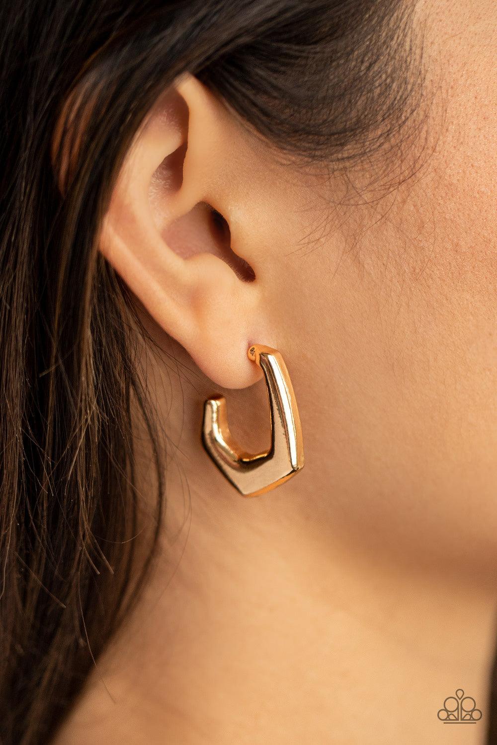 Paparazzi Accessories On The Hook - Gold A glistening gold bar curves into a hook shaped hoop, creating an edgy fashion. Earring attaches to a standard post fitting. Hoop measures approximately 3/4" in diameter. Sold as one pair of hoop earrings. Jewelry