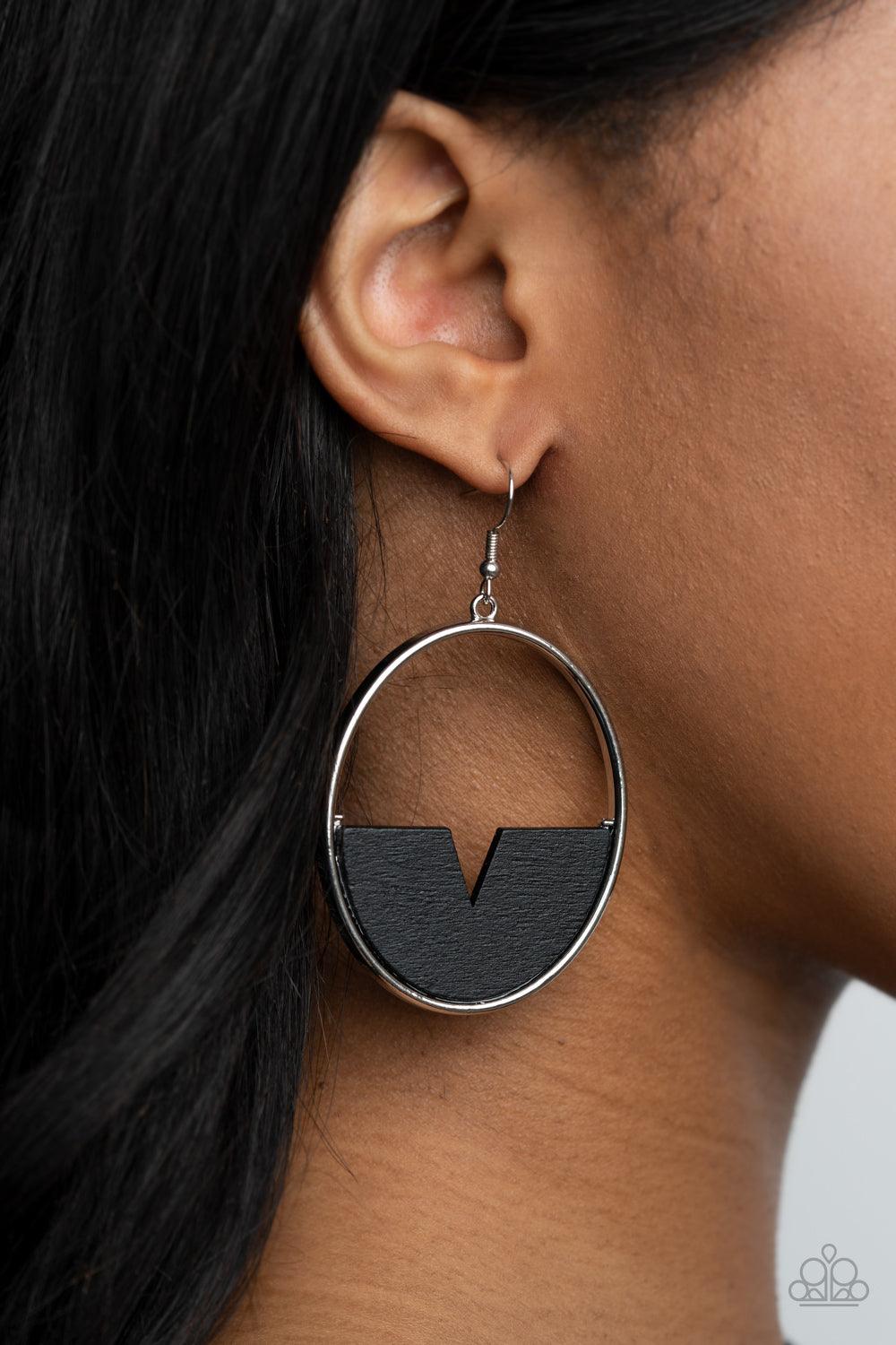 Paparazzi Accessories Island Breeze - Black Featuring a triangular cut, a crescent shaped black wooden frame is fitted in place along the bottom of a shiny silver hoop, creating a retro lure. Earring attaches to a standard fishhook fitting. Sold as one pa