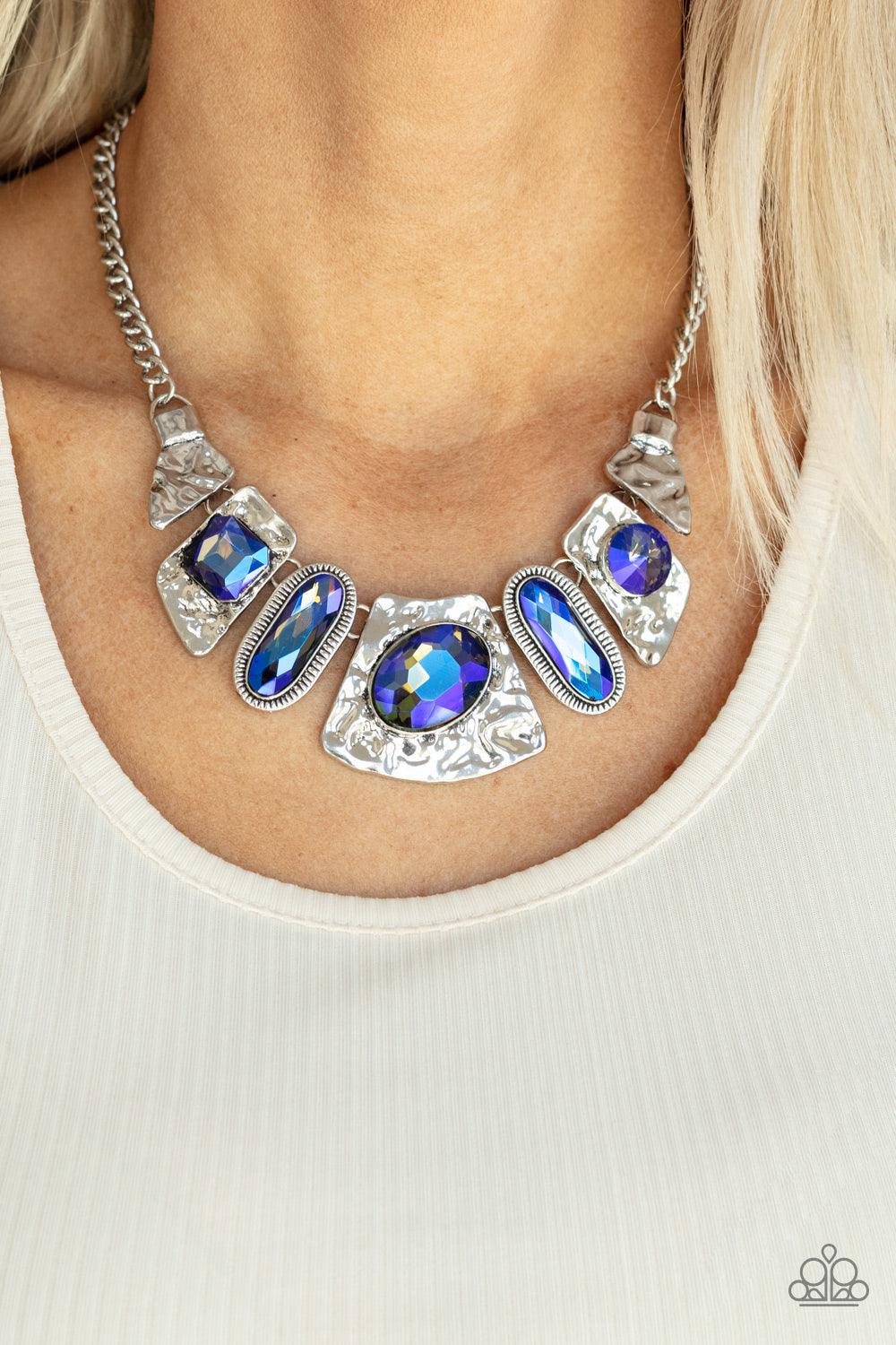 Paparazzi Accessories Futuristic Fashionista - Blue Mismatched French Blue gems adorn the front of hammered silver plates that abstractly connect below the collar, creating an out-of-this-world statement piece. Features an adjustable clasp closure. Sold a