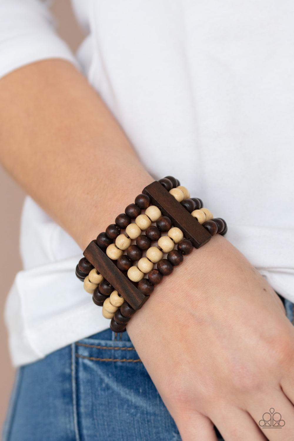 Paparazzi Accessories Caribbean Catwalk - Brown Held in place by rectangular wooden frames, strands of brown and white wooden beads are threaded along stretchy bands around the wrist for a colorfully tropical look. Sold as one individual bracelet. Jewelry