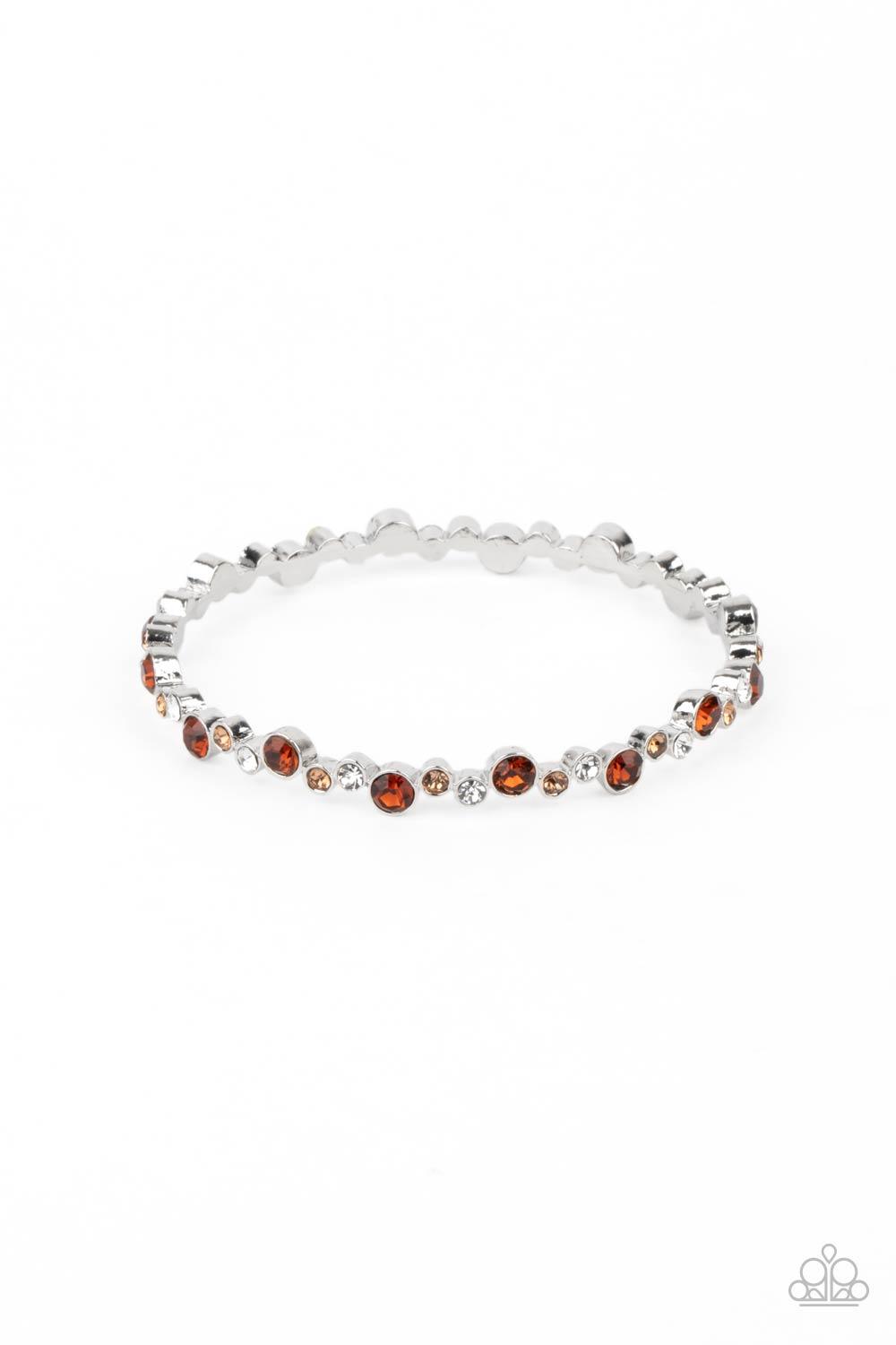 Paparazzi Accessories Twinkly Trendsetter - Brown Encased in sleek silver fittings, a twinkly collection of topaz, golden topaz, and white rhinestones coalesce into a glittery bangle around the wrist. Sold as one individual bracelet. Jewelry