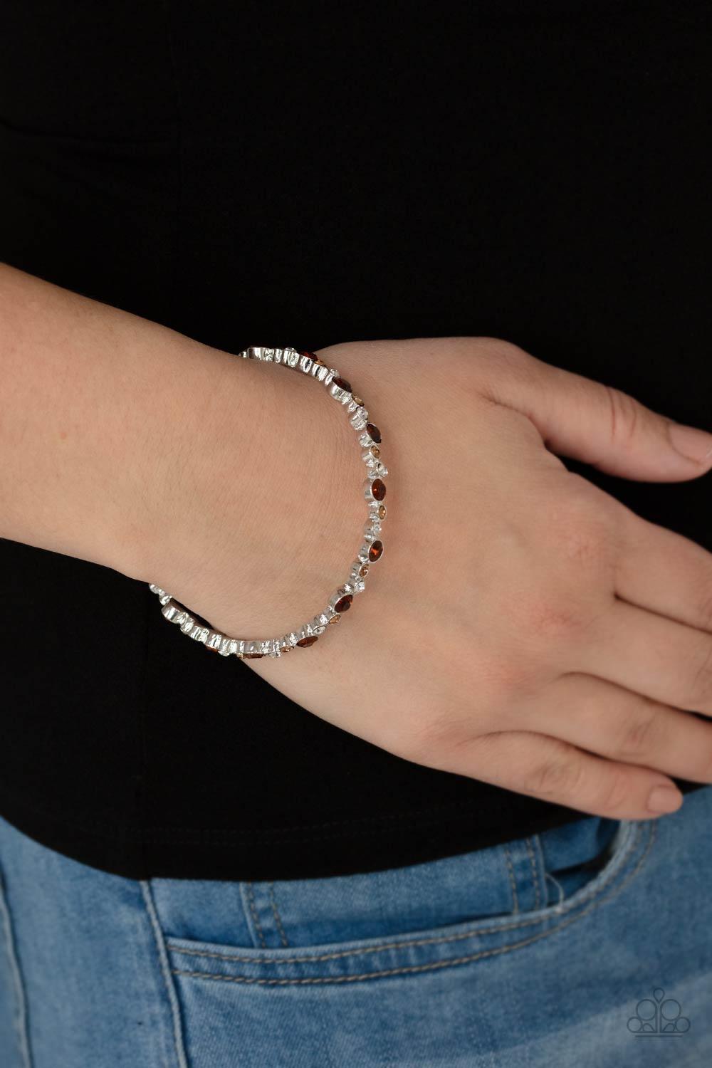 Paparazzi Accessories Twinkly Trendsetter - Brown Encased in sleek silver fittings, a twinkly collection of topaz, golden topaz, and white rhinestones coalesce into a glittery bangle around the wrist. Sold as one individual bracelet. Jewelry