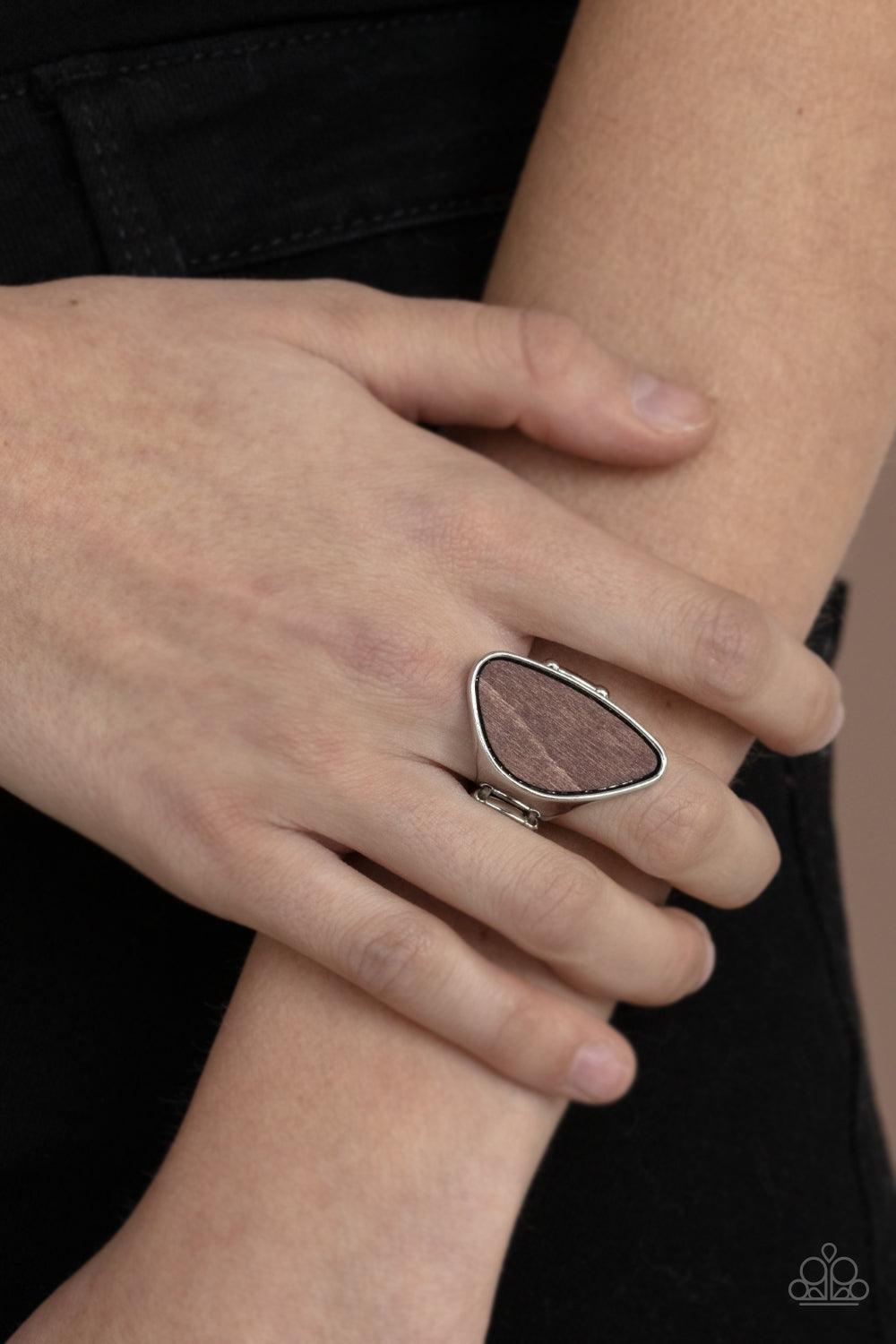 Paparazzi Accessories Perfectly Petrified - Brown An asymmetrical piece of rustic wood is nestled inside a sleek silver frame that thickens into a shimmery band around the finger, creating a refined centerpiece. Features a stretchy band for a flexible fit