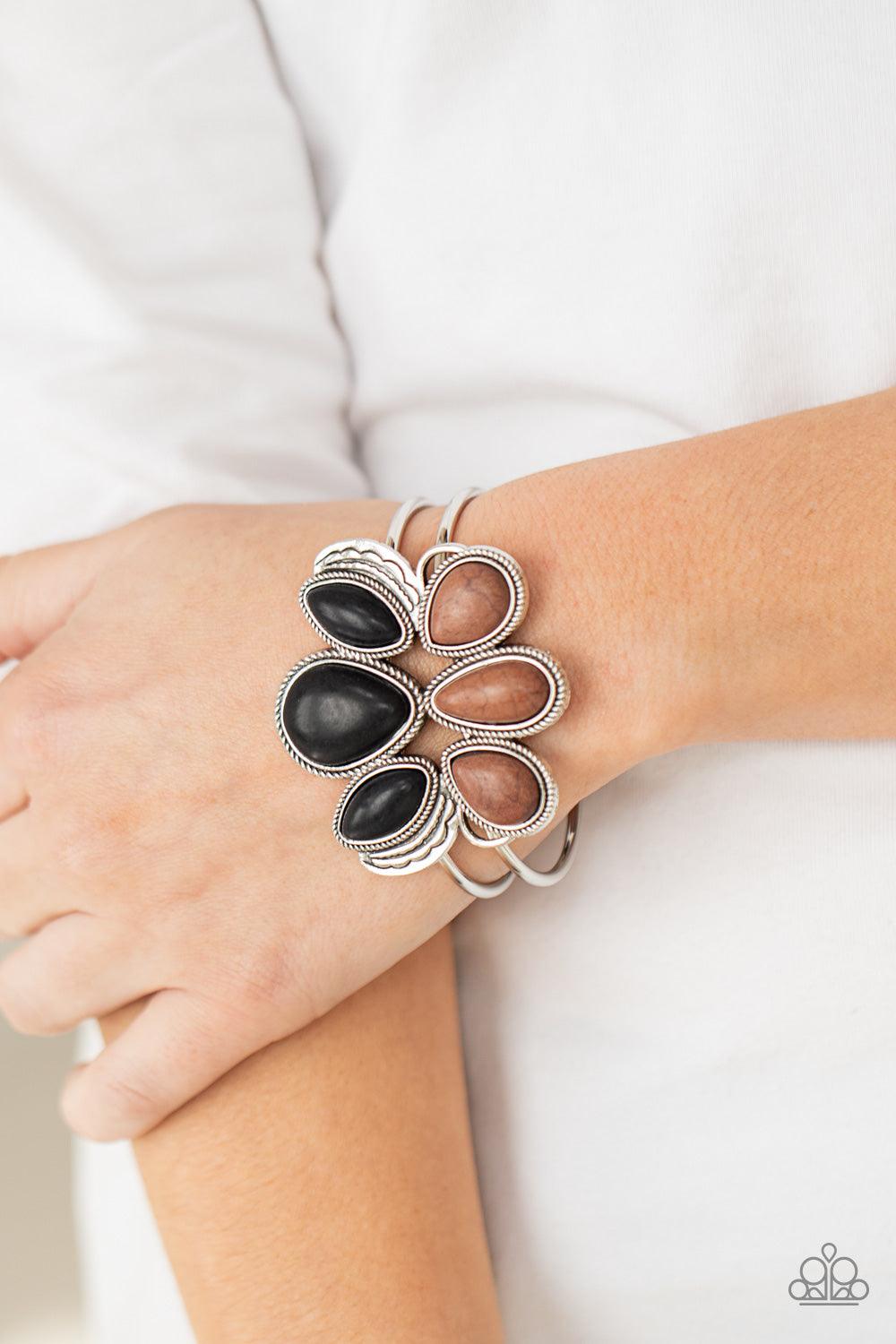 Paparazzi Accessories Botanical Badlands - Multi Encased in antiqued silver rope-like frames, a colorful collection of black and brown stone teardrops stack into a rustic centerpiece atop a layered silver cuff. Features an adjustable hinged closure. Sold