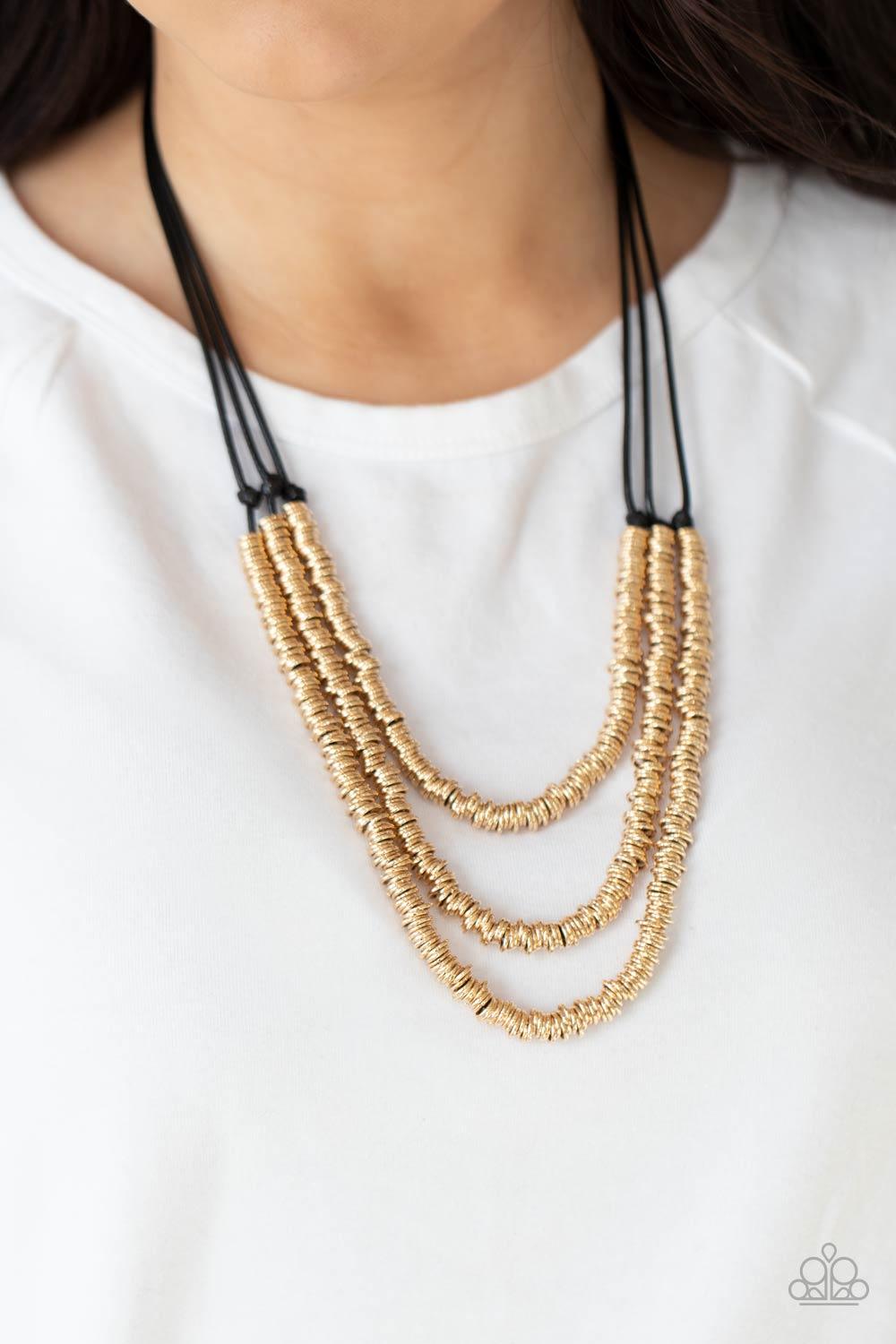 Paparazzi Accessories RING to Reason - Gold A seemingly infinite collection of dainty gold rings are knotted in place along three black cords, creating edgy layers across the chest. Features an adjustable clasp closure. Sold as one individual necklace. In