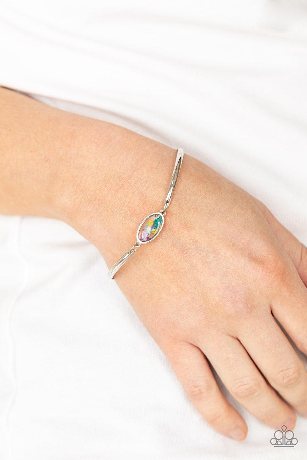 Paparazzi Accessories Farmhouse Fairytale - Multi A collection of colorful wildflowers is encased in a glassy casing bordered in silver that attaches to two shiny silver bars around the wrist, creating a whimsically dainty centerpiece. Features an adjusta