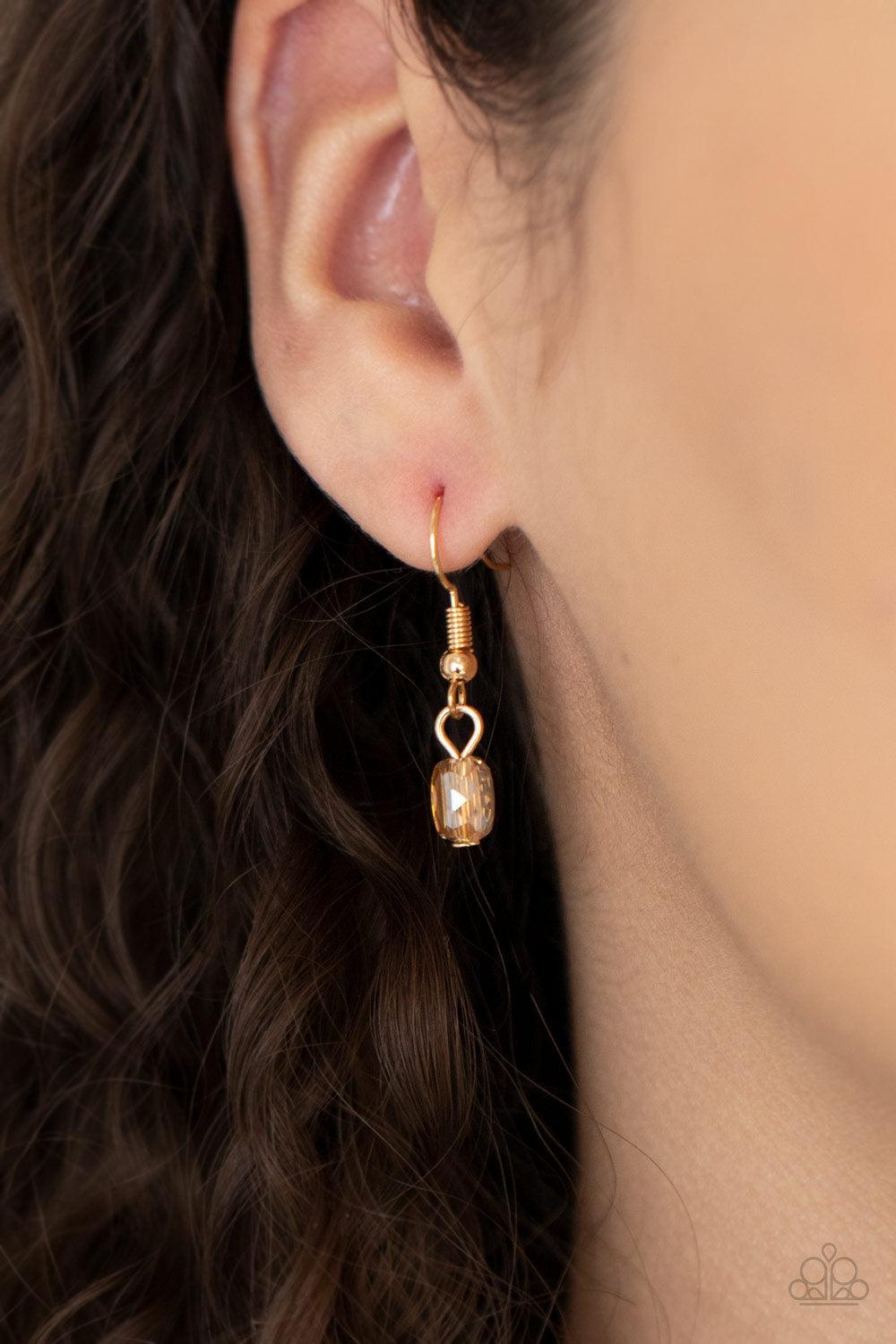Paparazzi Accessories Poshly Petite - Gold A posh collection of pearly white beads, accented with sections of flat, faceted shimmery transparent gold beads, is threaded along invisible wires, creating sophisticated layers that fall below the collar. Featu