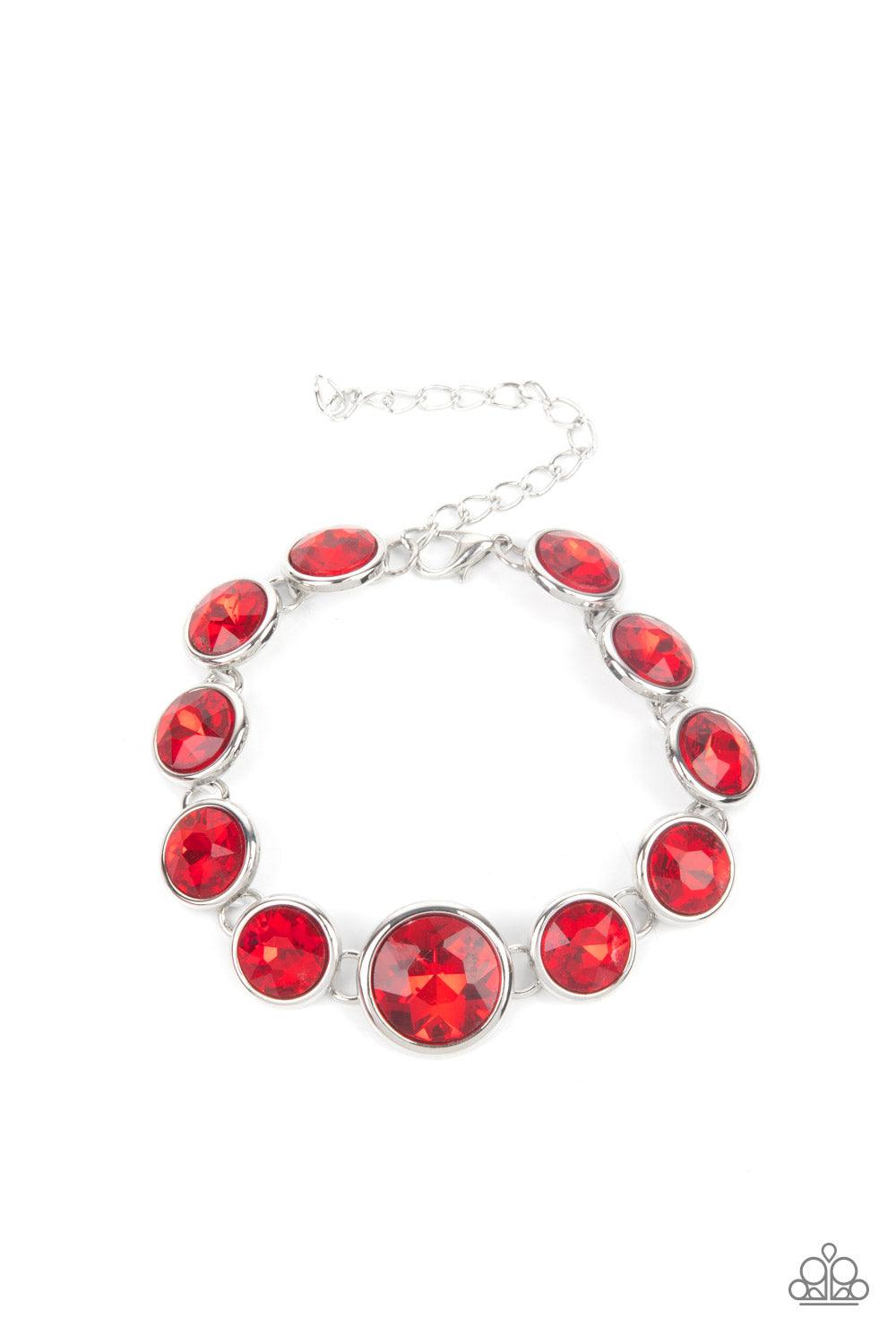 Paparazzi Accessories Lustrous Luminosity - Red Featuring sleek silver fittings, an oversized collection of fiery red gems delicately link around the wrist. The centermost gem is slightly larger than the rest, adding a glamorous finish. Features an adjust