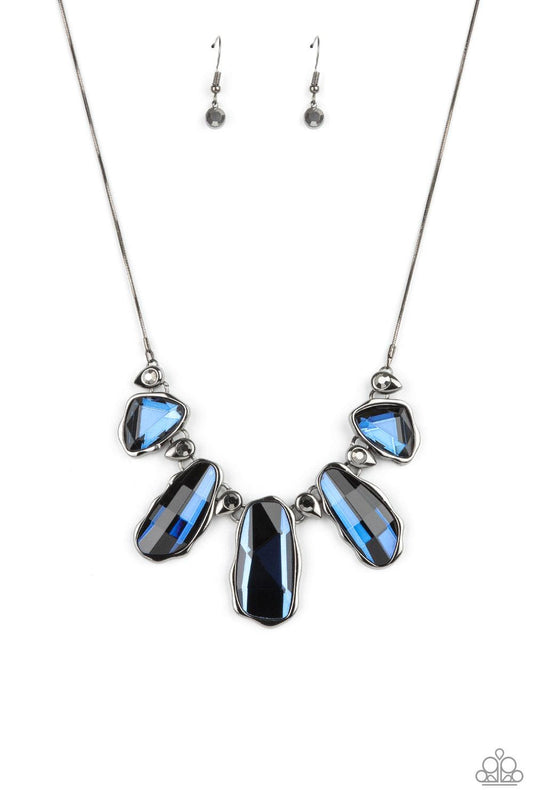 Paparazzi Accessories Cosmic Cocktail - Blue A glittery collection of raw cut blue gems delicately link with dainty hematite rhinestone dotted gunmetal teardrops below the collar, creating a stellar fringe. Features an adjustable clasp closure. Sold as on