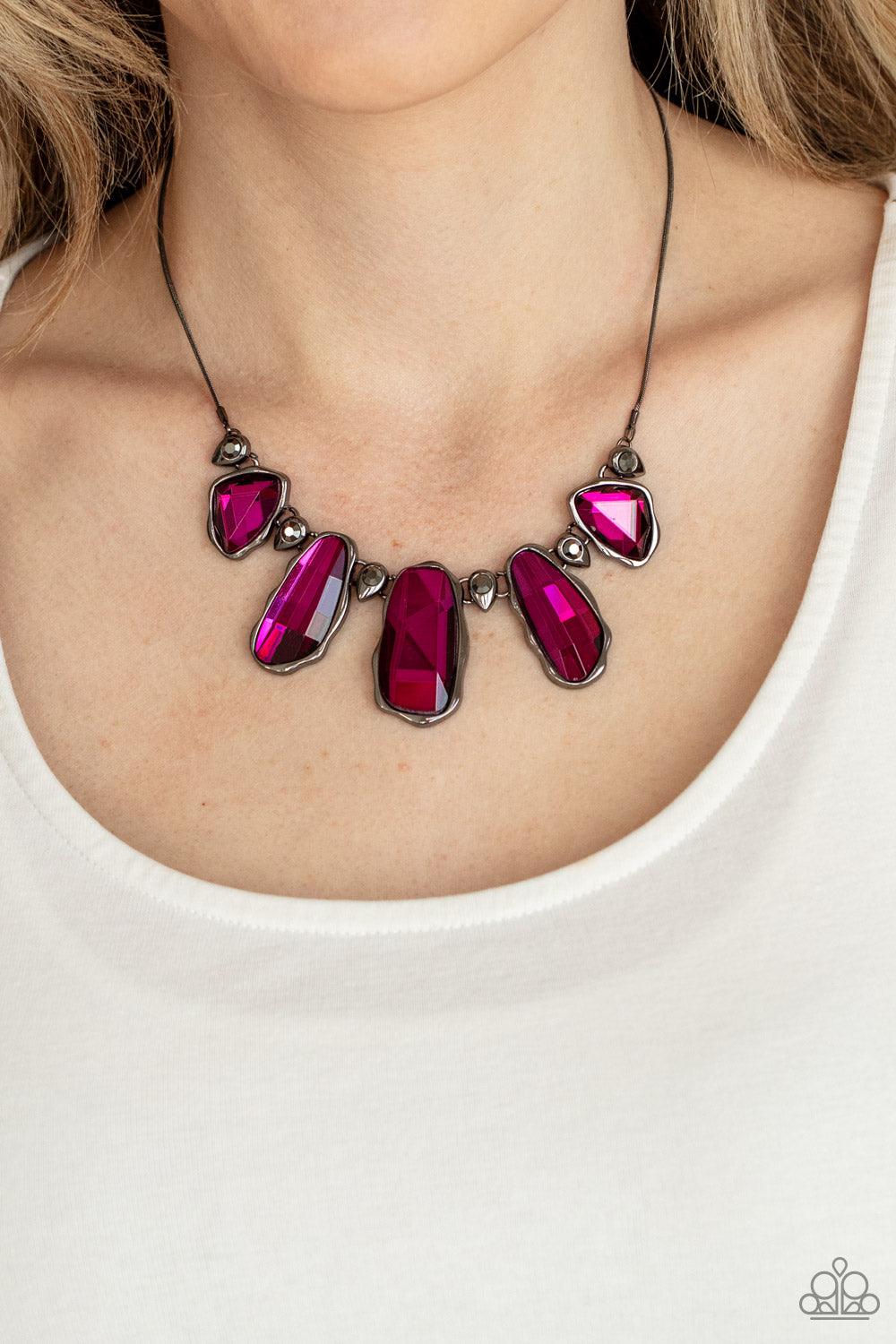 Paparazzi Accessories Cosmic Cocktail - Pink A glittery collection of raw cut pink gems delicately link with dainty hematite rhinestone dotted gunmetal teardrops below the collar, creating a stellar fringe. Features an adjustable clasp closure. Sold as on