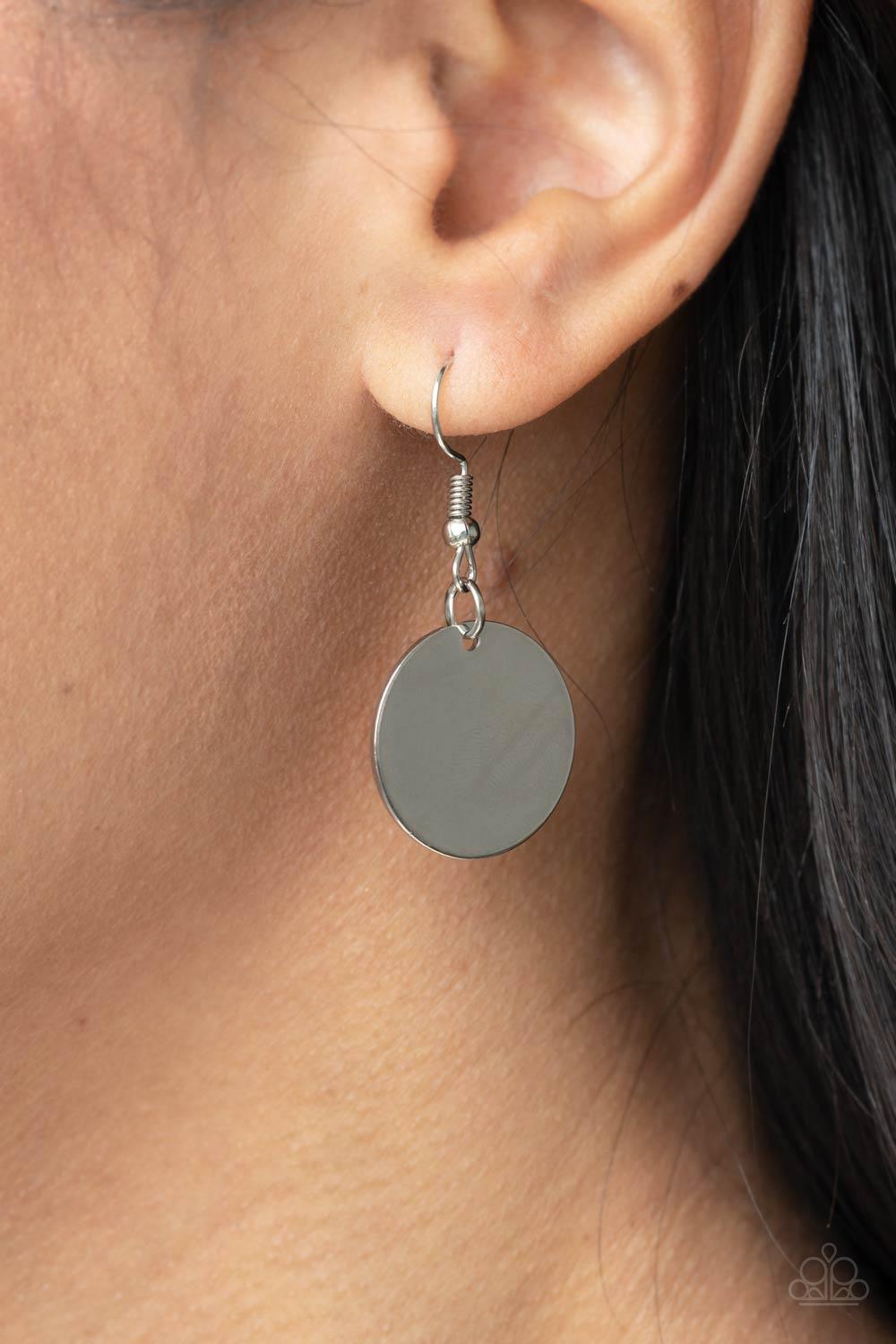 Paparazzi Accessories Luxe Crush - Black A large cutout silver disc, overlaid with black leather, is cradled in a wide black leather strap. The luxe pendant sways from a U-shaped silver cylinder threaded along the end of a lengthened polished black cord f