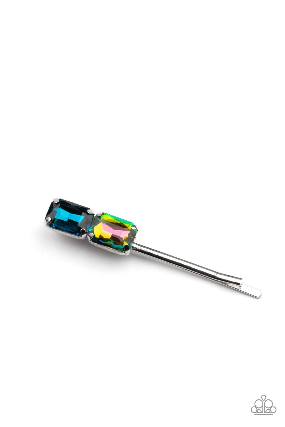 Paparazzi Accessories Material Girl Goals - Blue Featuring elegant emerald style cuts, an oversized pair of blue and oil spill rhinestones adorn the end of a classic silver bobby pin. Sold as one individual bobby pin. Brooches & Lapel Pins