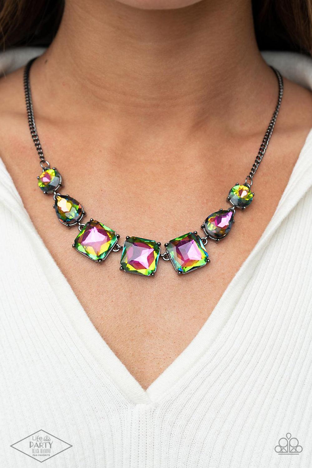 Paparazzi Accessories Unfiltered Confidence - Multi A trio of brilliant oil spill square gut gems encased in classic gunmetal fittings takes center stage. Teardrop and round oil spill gems link to a gunmetal chain on either side of the trio for a striking
