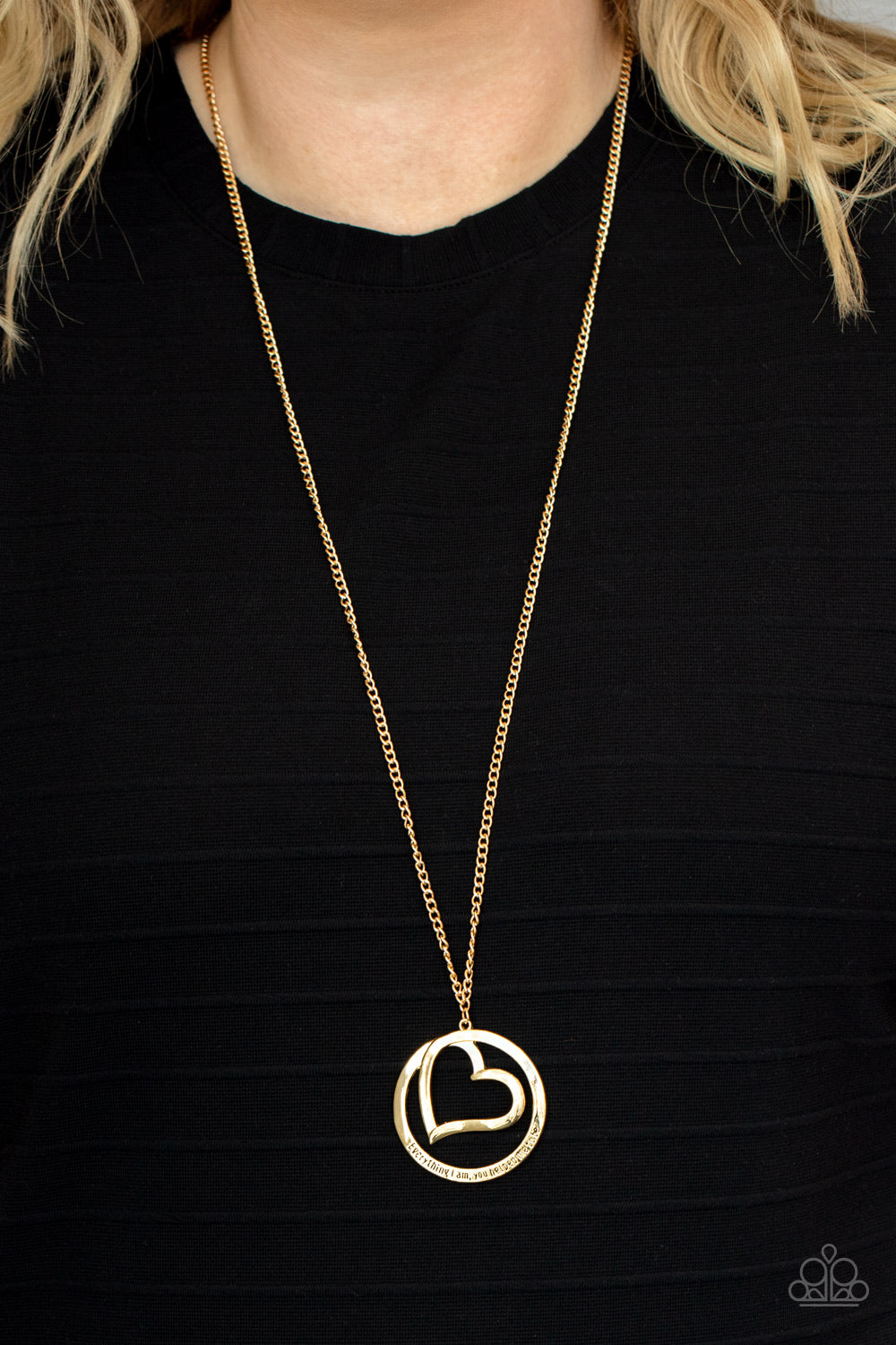 Paparazzi Accessories Positively Perfect - Gold An airy gold circular frame wraps around to enclose a gold heart. The frame is inscribed with the words, "Everything I am, you helped me to be," for a positively lovely pendant swinging from a lengthened gol