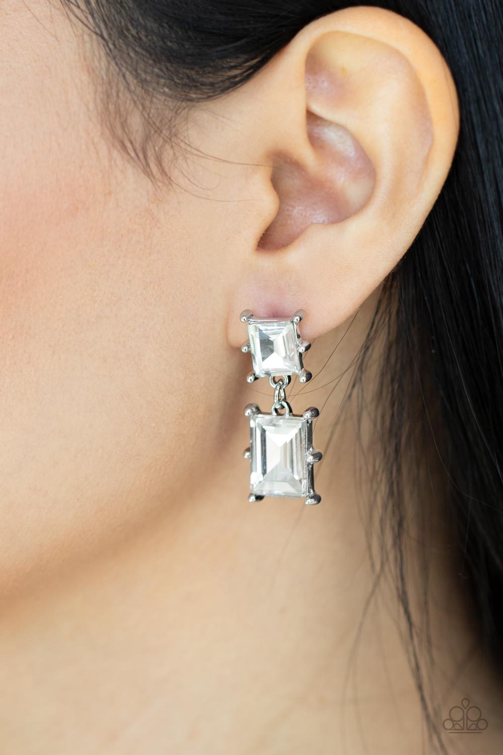 Paparazzi Accessories Cosmic Queen - White Two brilliant baguette cut white rhinestones, set in classic silver pronged settings, stack one over the other creating a cosmically radiant statement. Earring attaches to a standard post fitting. Sold as one pai