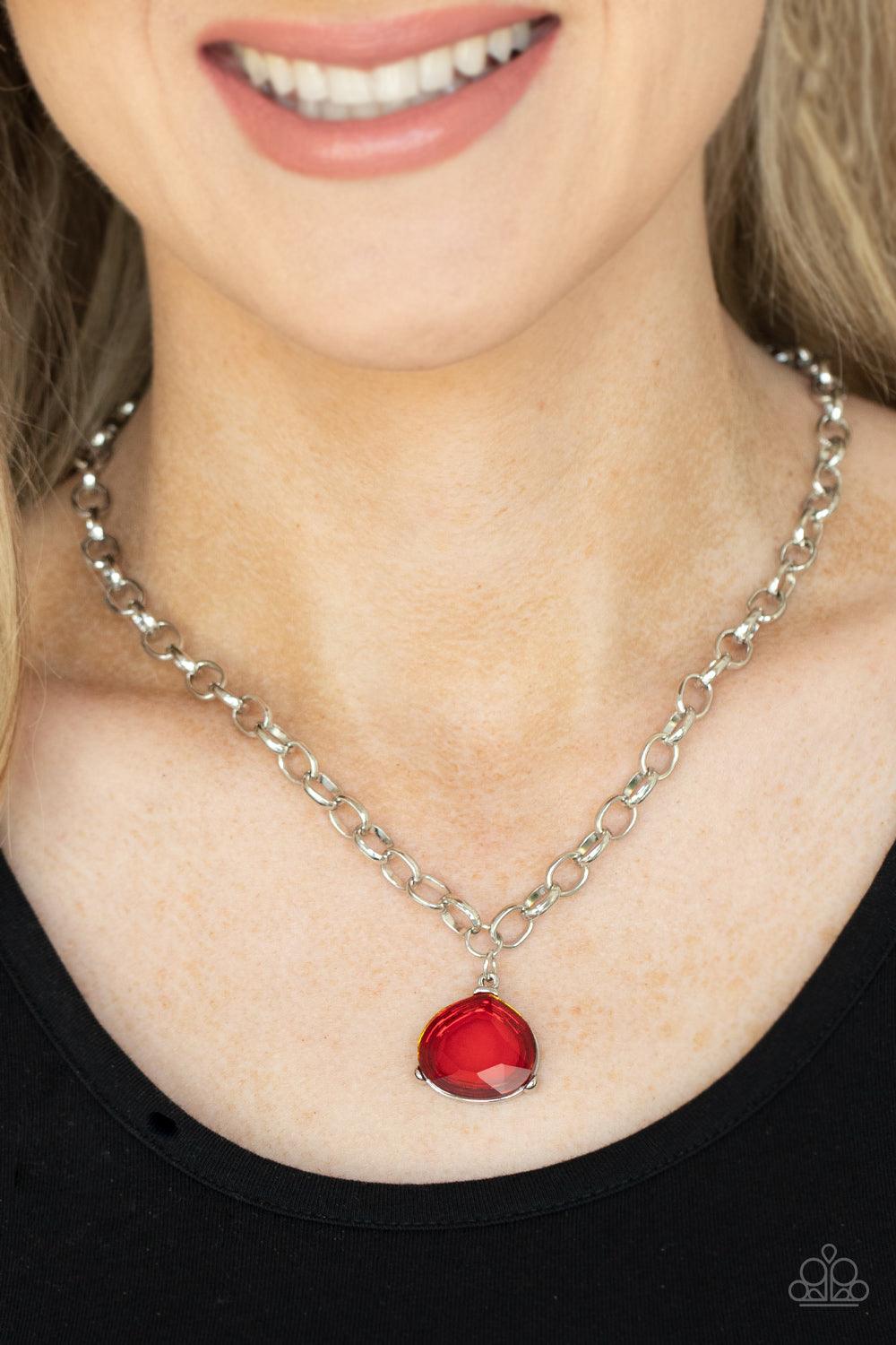 Paparazzi Accessories Gallery Gem - Red An oversized glassy red gem is pressed into a pronged silver fitting at the bottom of a chunky silver chain, creating a dramatic pendant below the collar. Features an adjustable clasp closure. Sold as one individual