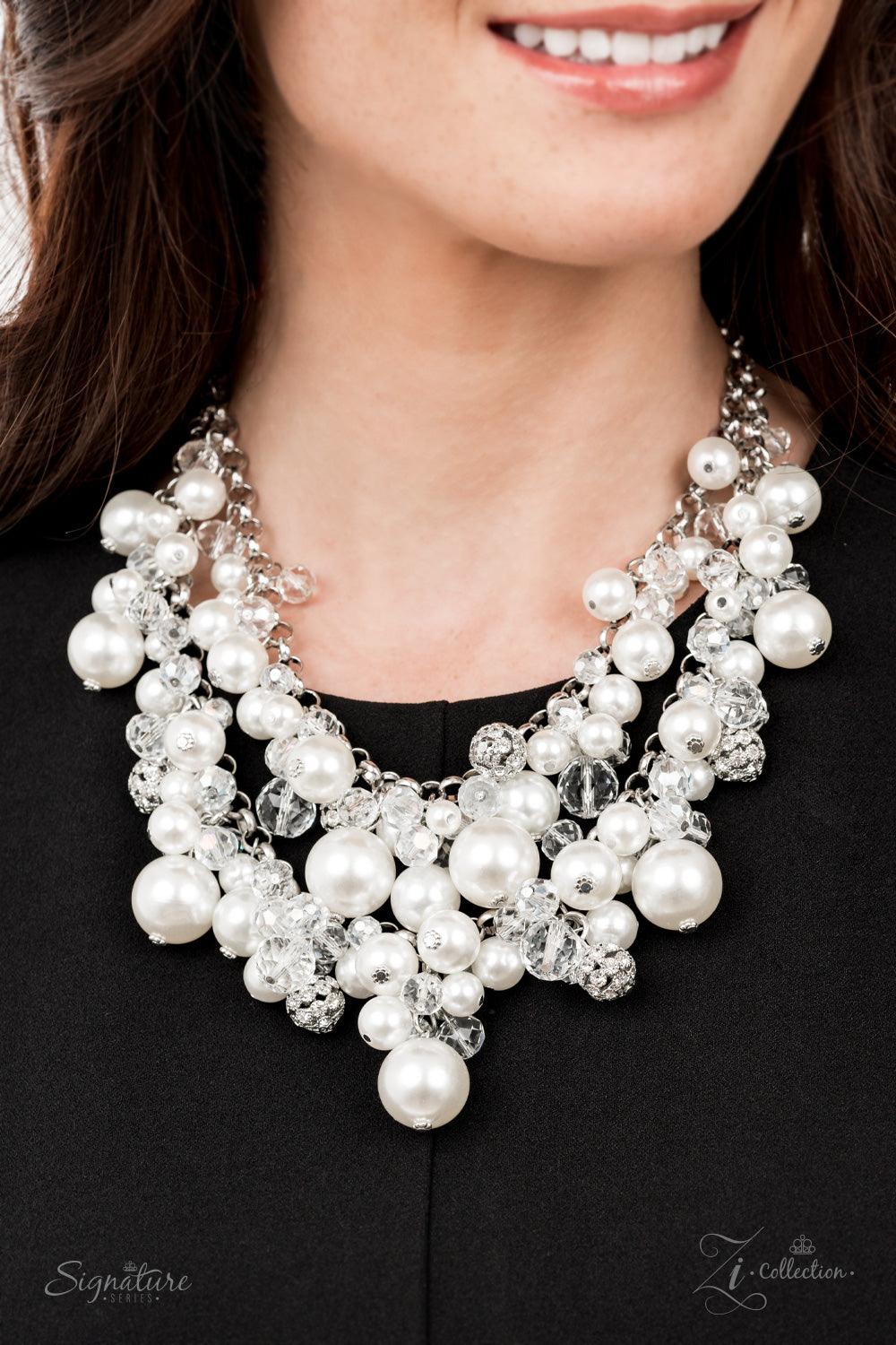 Paparazzi Accessories The Janie An elegantly effervescent collection of oversized pearls, glassy crystal-like beads, and white rhinestone studded silver ornaments effortlessly clusters along two bold silver chains below the collar. The bubbly bunched acce