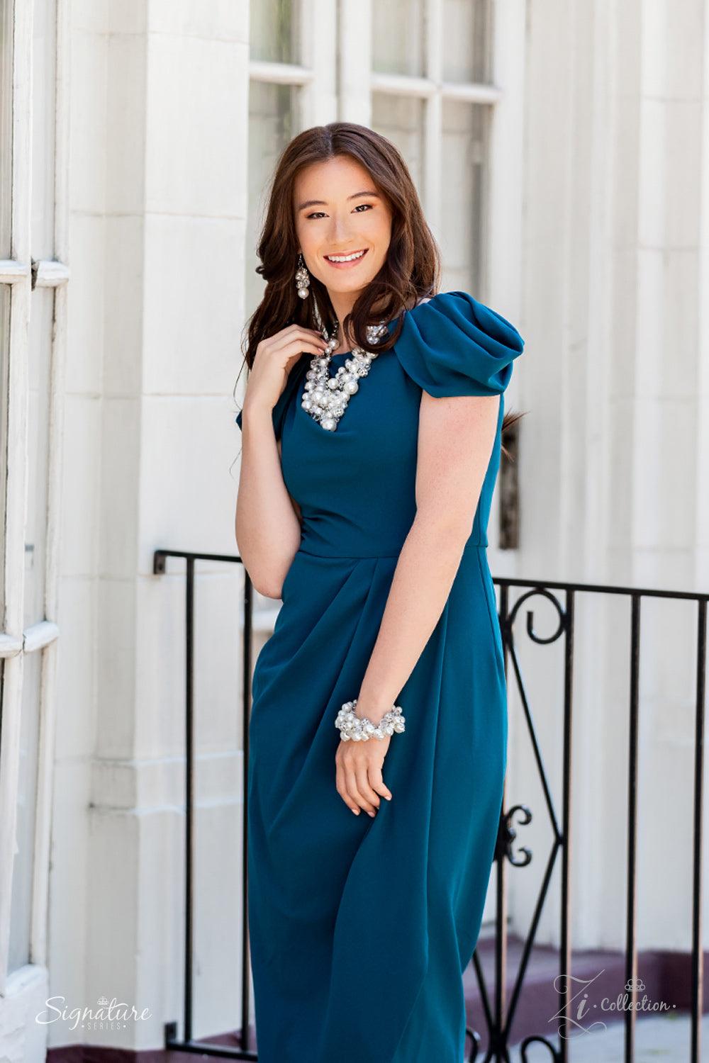 Paparazzi Accessories The Janie An elegantly effervescent collection of oversized pearls, glassy crystal-like beads, and white rhinestone studded silver ornaments effortlessly clusters along two bold silver chains below the collar. The bubbly bunched acce