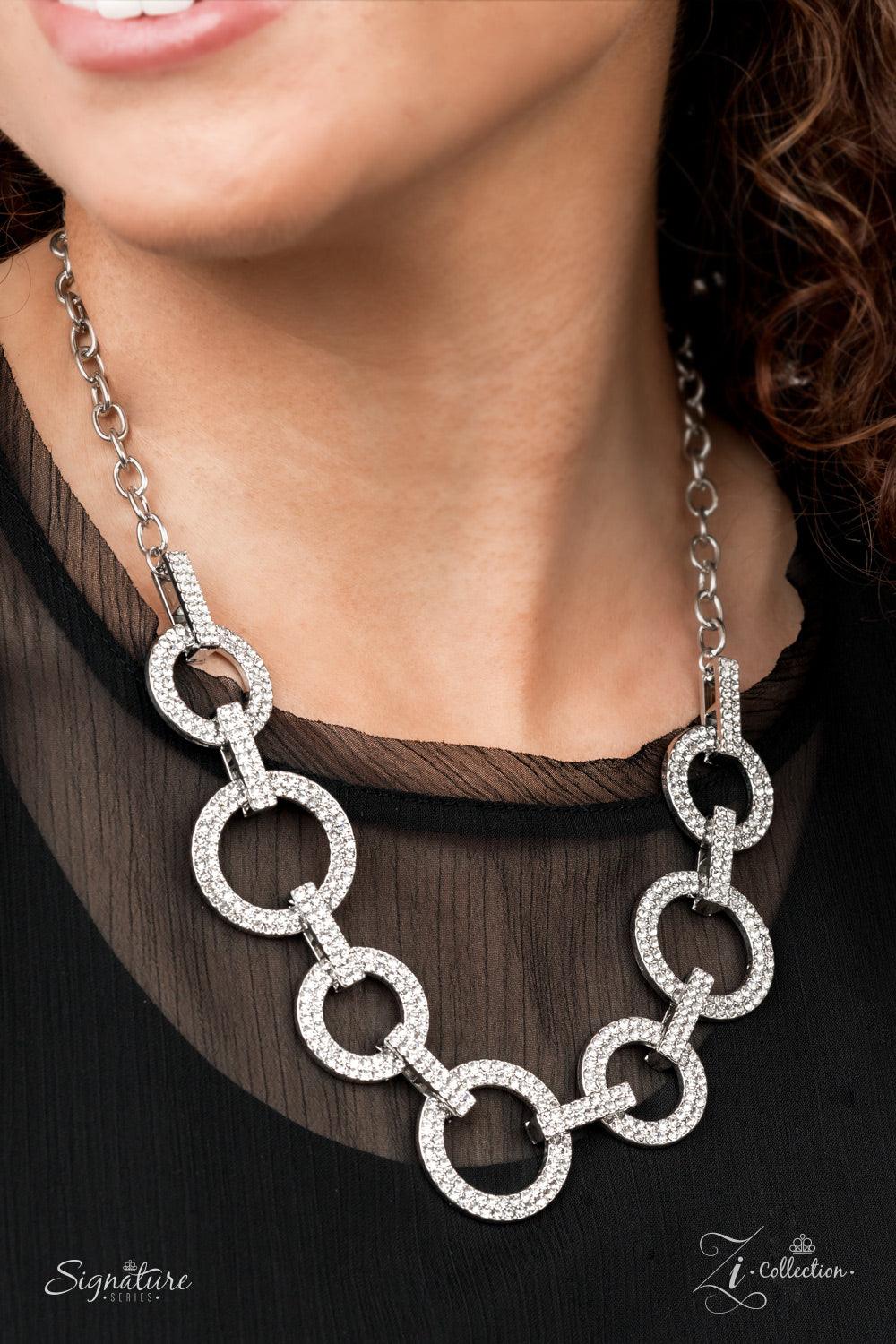 Paparazzi Accessories The Missy Elegantly enhanced with white rhinestone encrusted links, an effervescent array of white rhinestone encrusted silver hoops glamorously alternate below the collar for an unapologetically audacious sparkle. Features an adjust