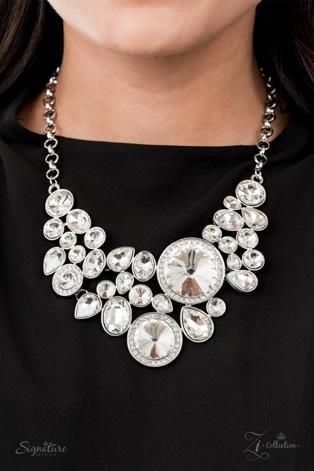 Paparazzi Accessories The Danielle Featuring an oversized collection of round, oval, and teardrop white rhinestones, an exaggerated explosion of dynamite dazzle coalesces into three separate frames below the collar. The combustible frames flawlessly link