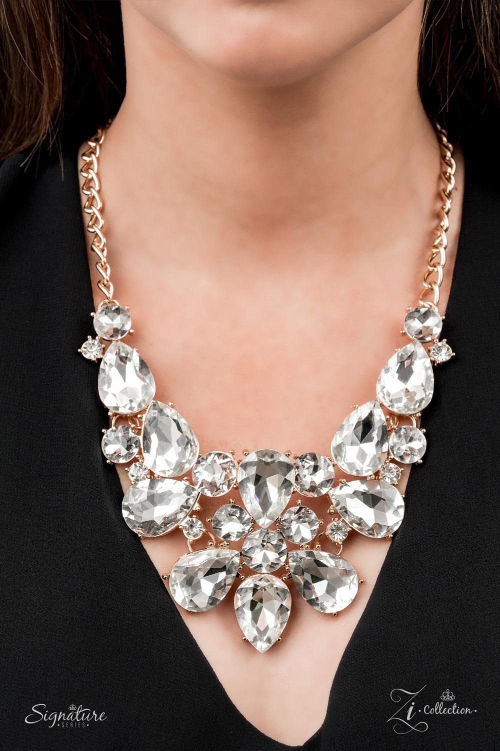 Paparazzi Accessories The Bea An elaborately exaggerated display of oversized round and teardrop white rhinestones classically coalesces into majestically mismatched golden frames. The dauntless dazzle delicately links below the collar, creating a stunnin