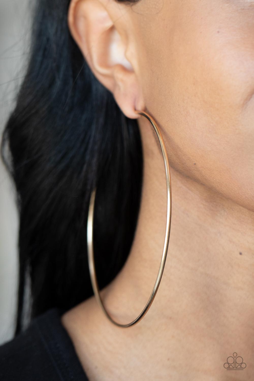 Paparazzi Accessories Colossal Couture - Gold A classic gold bar curls into an outrageously oversized hoop for a trendsetting look. Earring attaches to a standard post fitting. Hoop measures approximately 4" in diameter. Sold as one pair of hoop earrings.